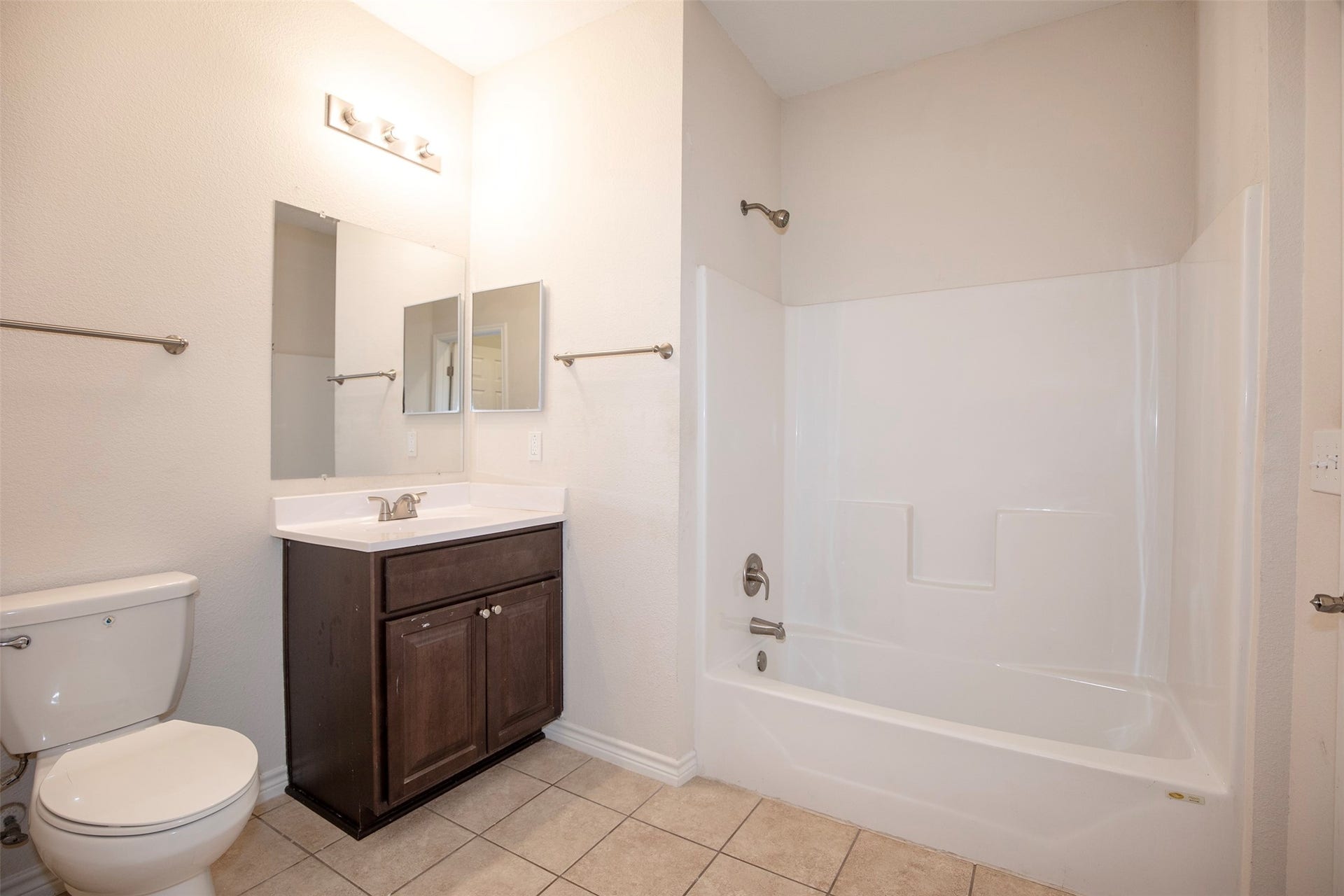 The primary bathroom has terrific lighting and a large walk-in closet.