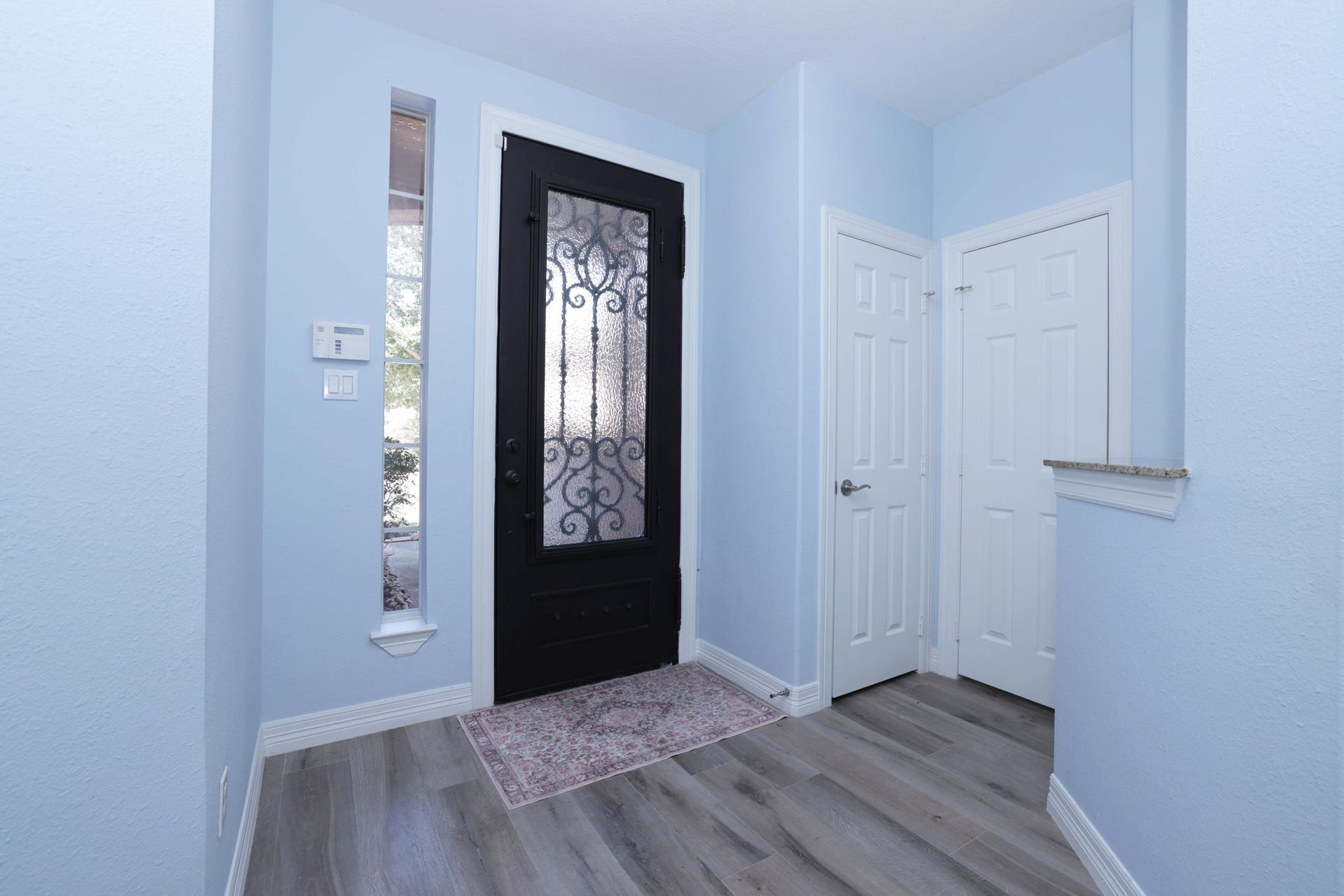18302 Rittenhouse Park Court, Spring, TX 77379 The entry is light and bright with the glass door and side light.