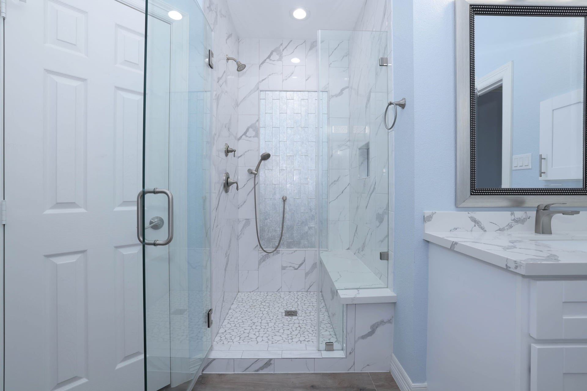 18302 Rittenhouse Park Court, Spring, TX 77379 The giant shower has designer tile, a built in bench, hand held sprayer, and frameless glass door shower.