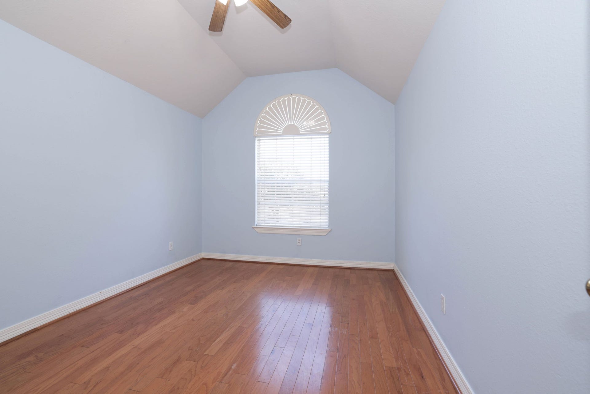 18302 Rittenhouse Park Court, Spring, TX 77379 Bedroom 3 continues with wood floor, tall ceiling, fan anf fresh paint.