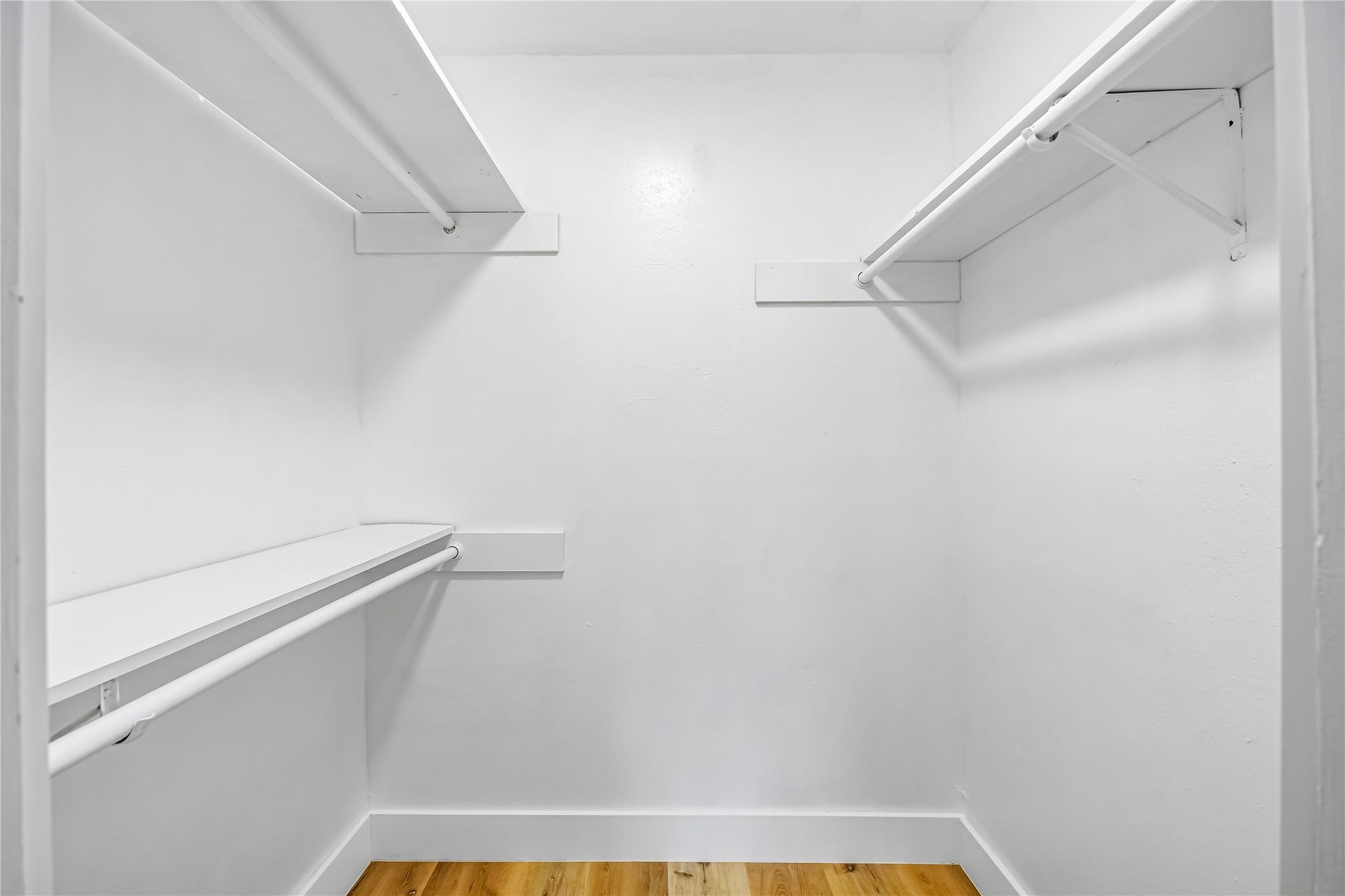 1803 Thornbrook Drive, Missouri City, TX 77489 Spacious walk-in closet featuring multiple hanging rods and built-in shelving for organized storage. The bright, clean layout offers plenty of room for clothing, shoes, and accessories while keeping everything easily accessible.
