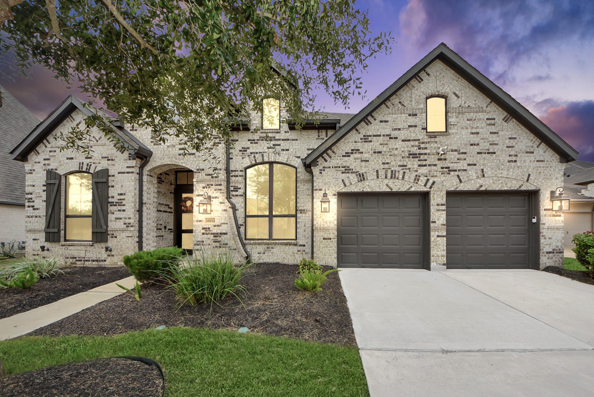 10014 Galileo Lane, Iowa Colony, TX 77583 Beautiful brick and stone exterior with inviting curb appeal and an attached two-car garage.