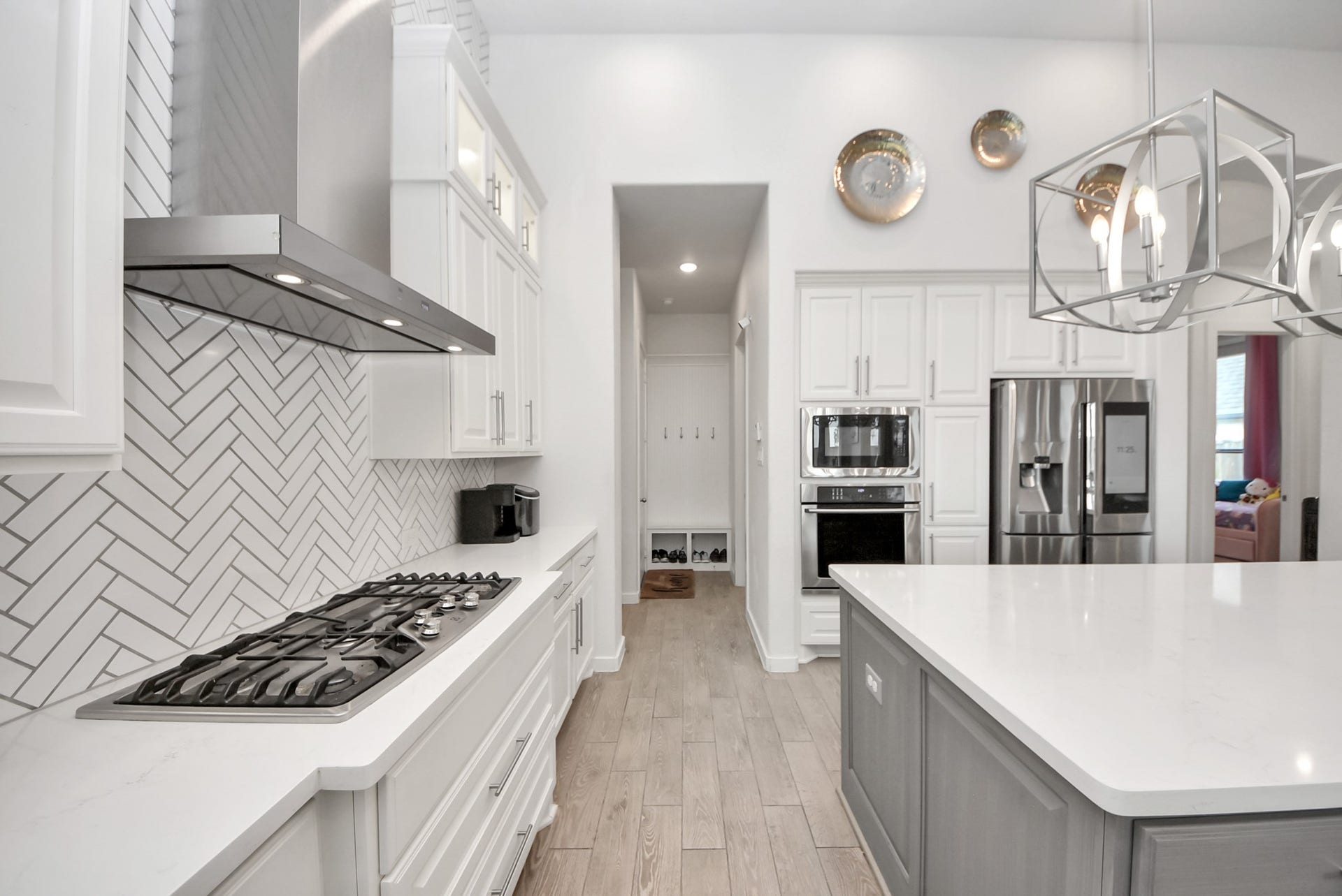 10014 Galileo Lane, Iowa Colony, TX 77583 Modern kitchen with sleek countertops, stainless steel appliances, and elegant lighting.