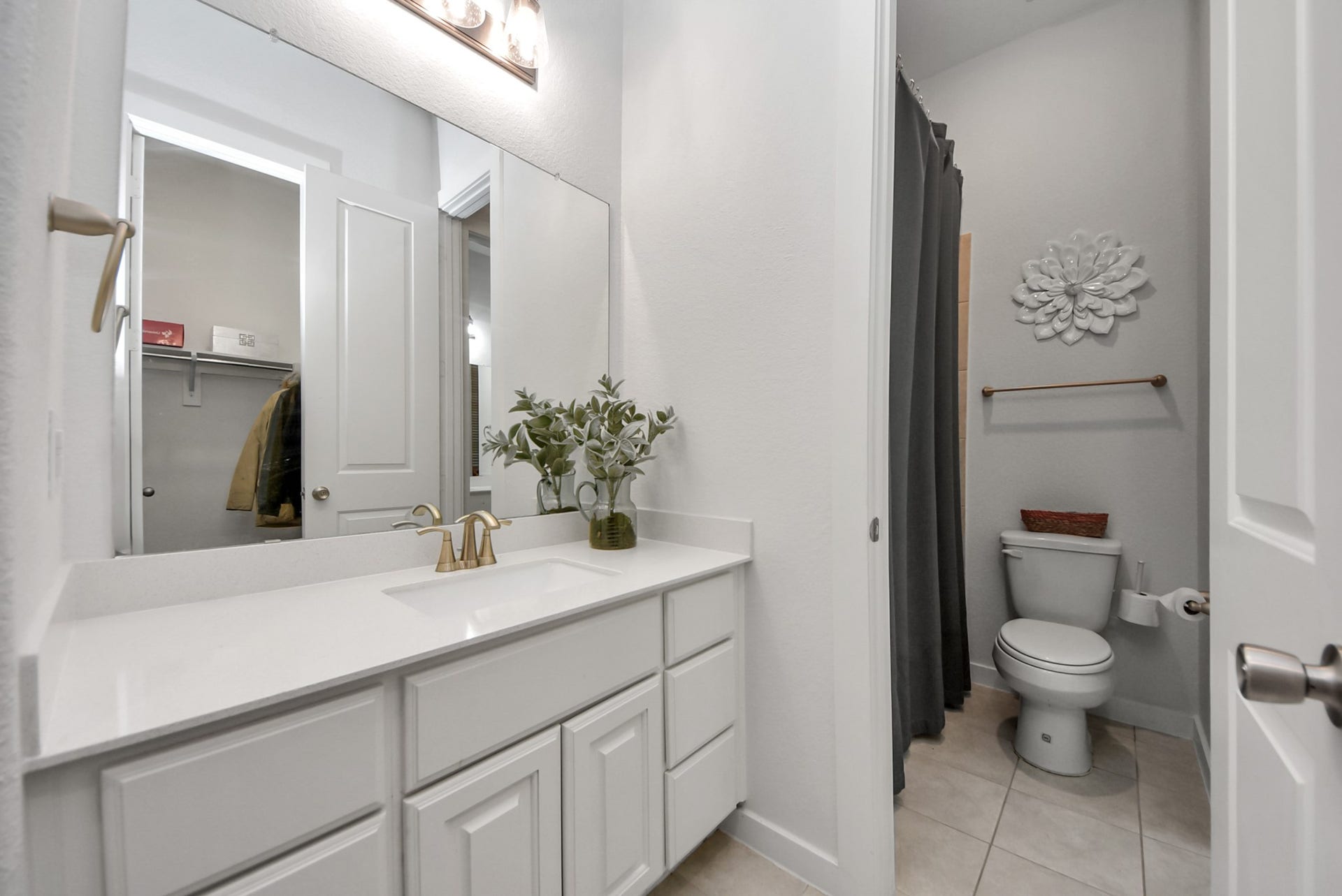 10014 Galileo Lane, Iowa Colony, TX 77583 Bright bathroom with an extended vanity, modern fixtures, and neutral finishes.