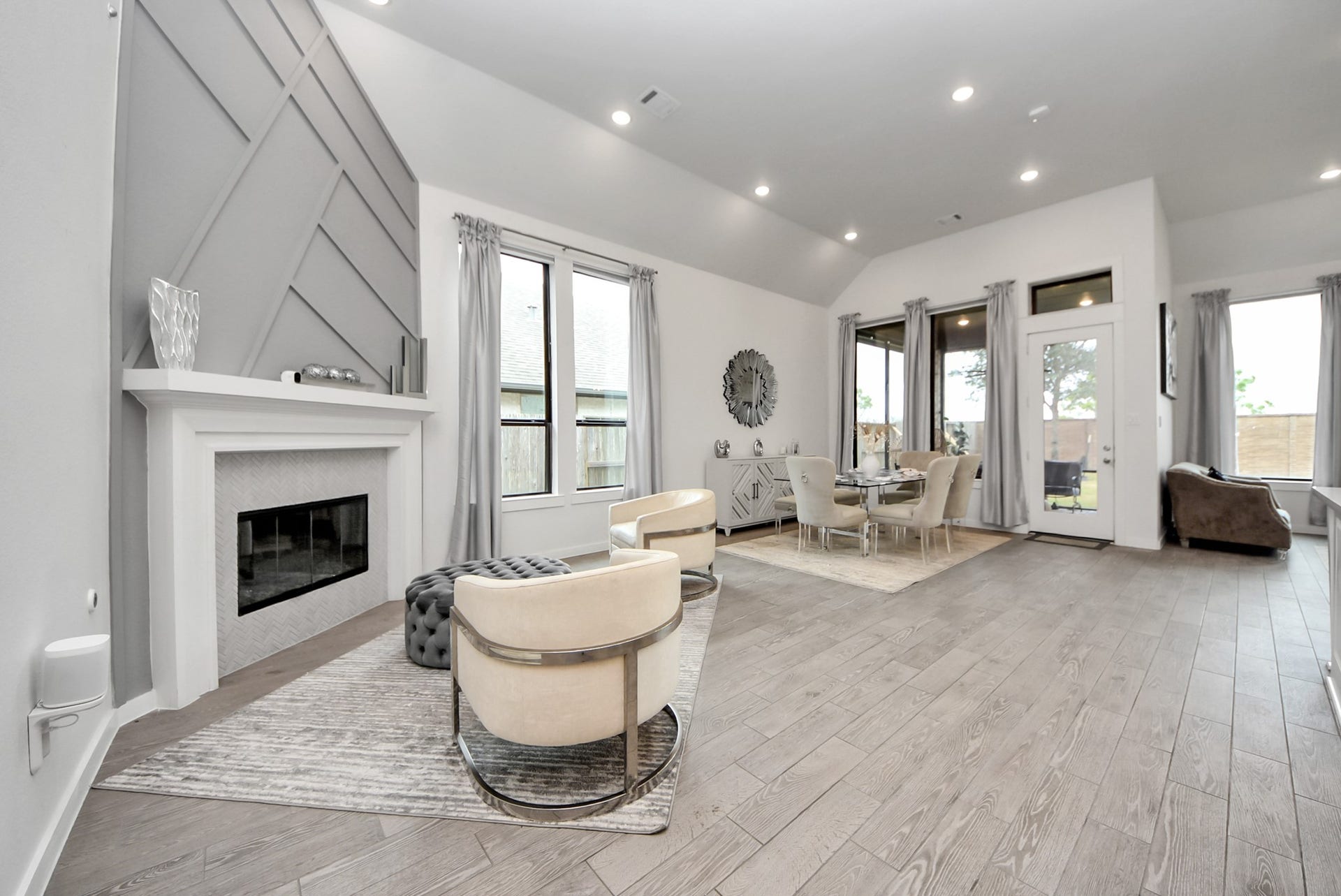 10014 Galileo Lane, Iowa Colony, TX 77583 Spacious living area featuring a cozy fireplace and an open-concept layout.