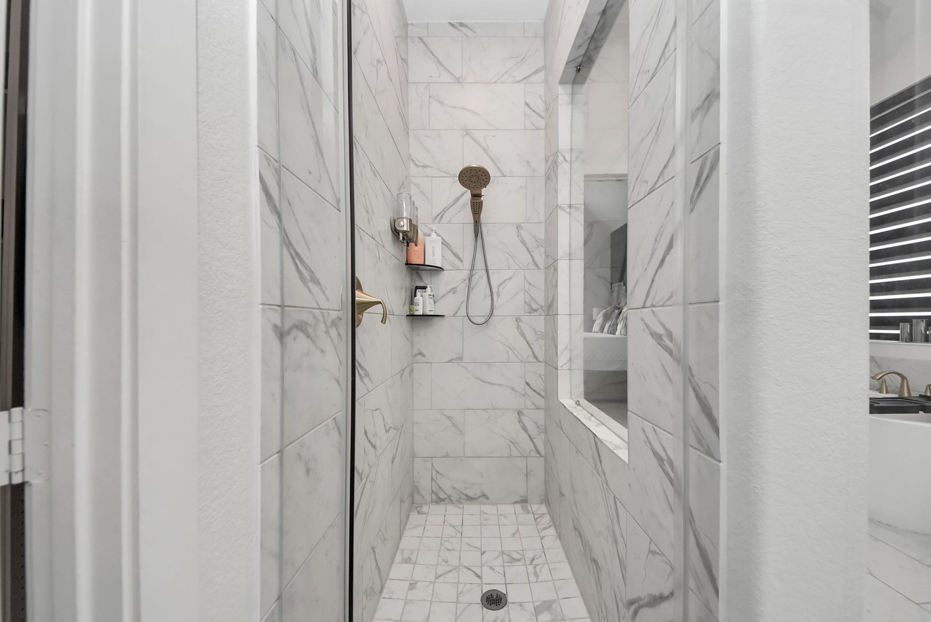 10014 Galileo Lane, Iowa Colony, TX 77583 Stylish walk-in shower featuring attractive tilework and glass enclosure.
