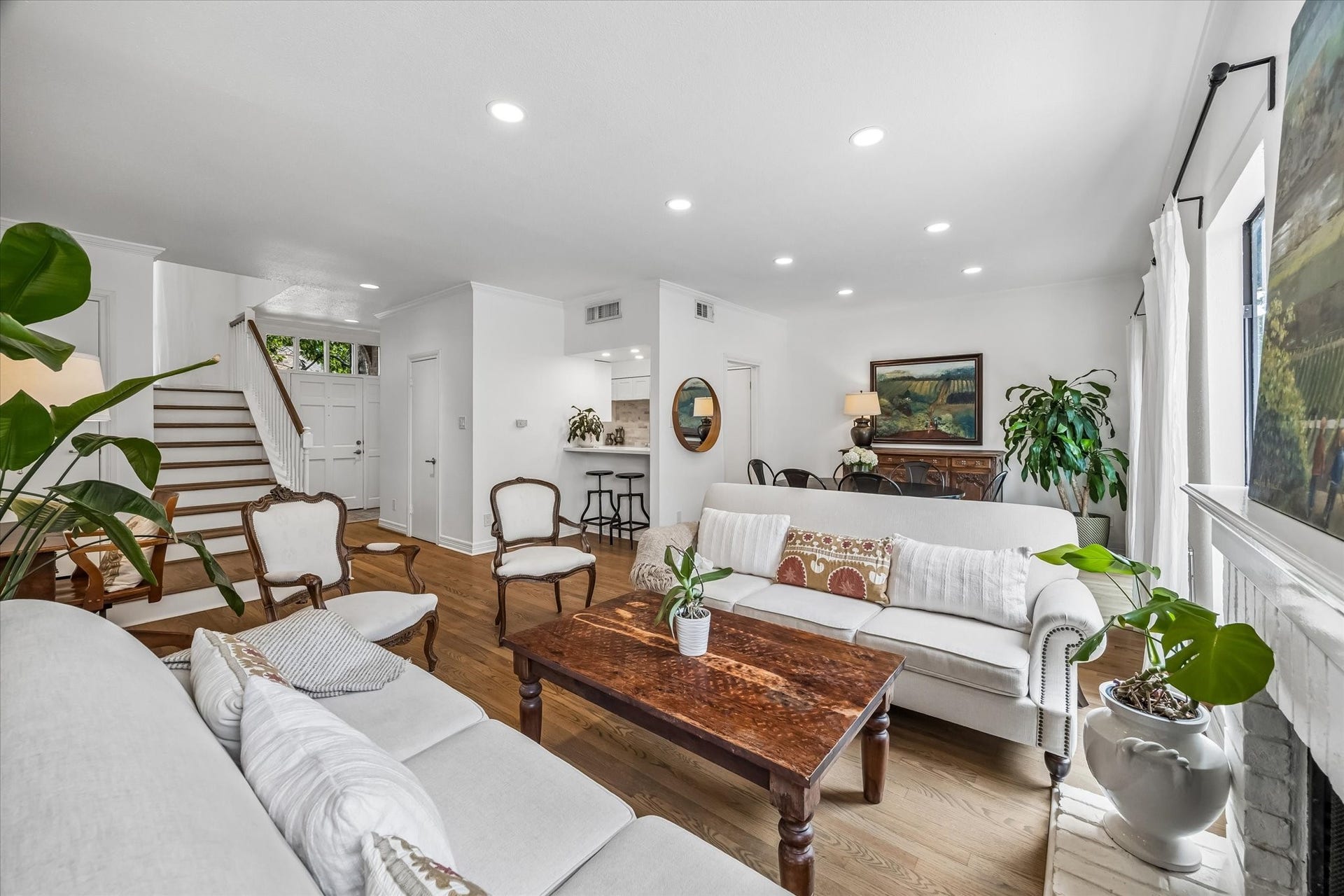 A classic staircase adds character, while the open layout seamlessly connects to the dining space. Storage closet under the stairs, has been refreshed.