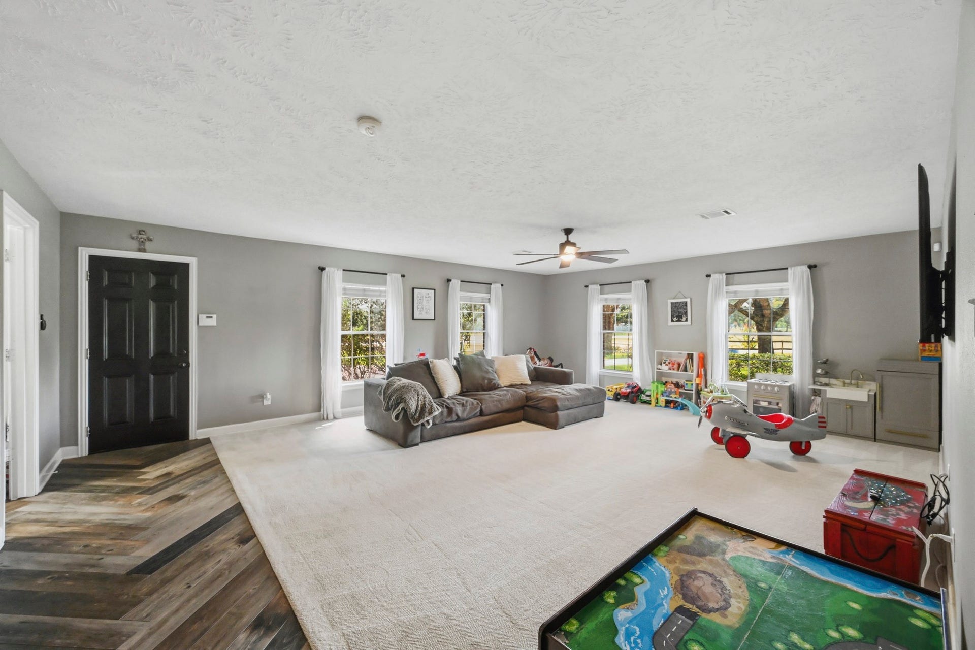 5202 Cherry Ridge Road, Richmond, TX 77406 Spacious game room with access to the garage and views of the wooded front yard.