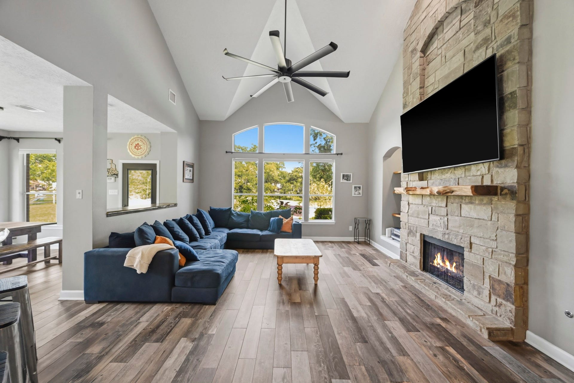 5202 Cherry Ridge Road, Richmond, TX 77406 Inviting family room with soaring ceilings, a floor-to-ceiling stone fireplace, and breathtaking backyard views.