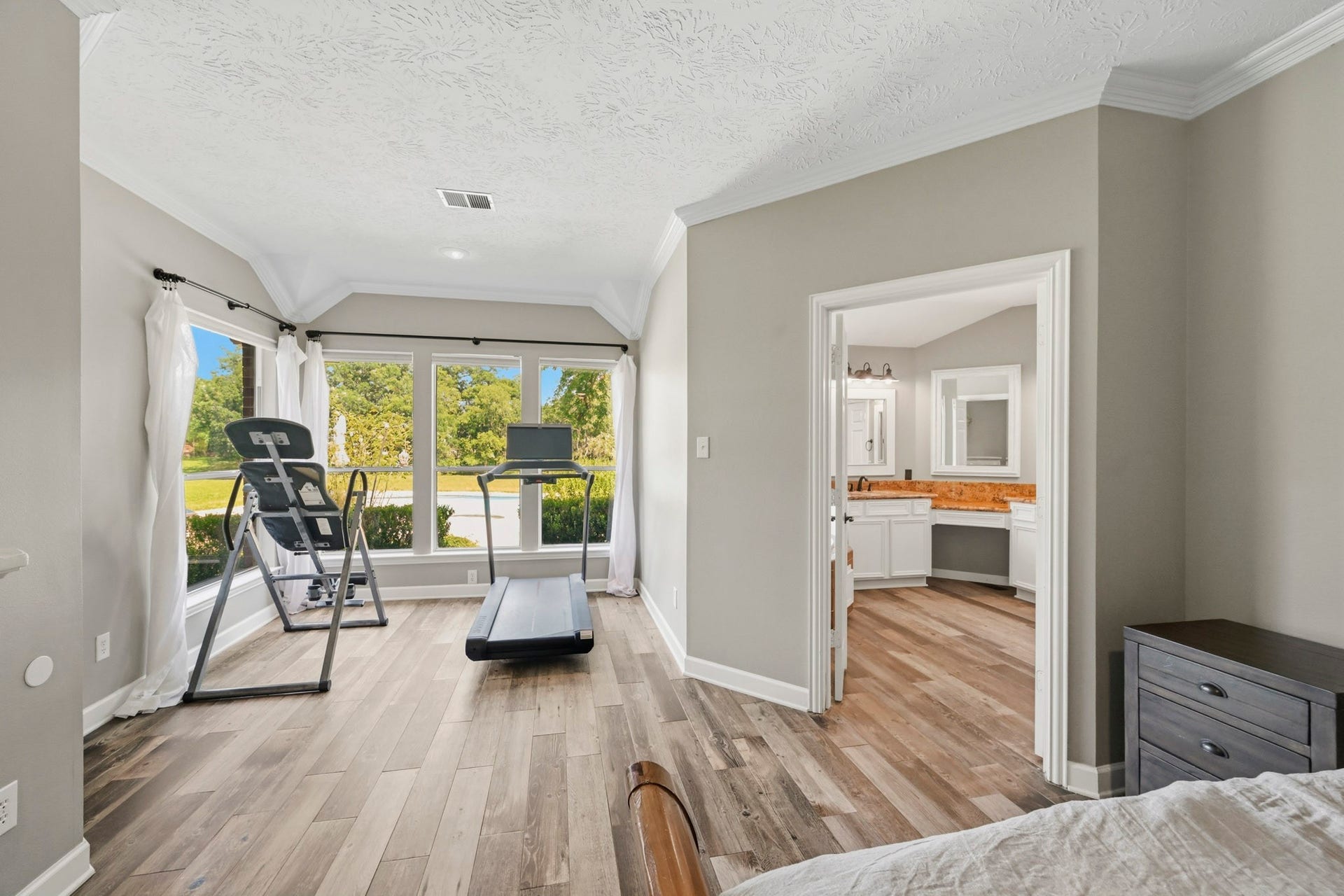 5202 Cherry Ridge Road, Richmond, TX 77406 Primary suite overlooking the heated pool, spa, and private backyard retreat.