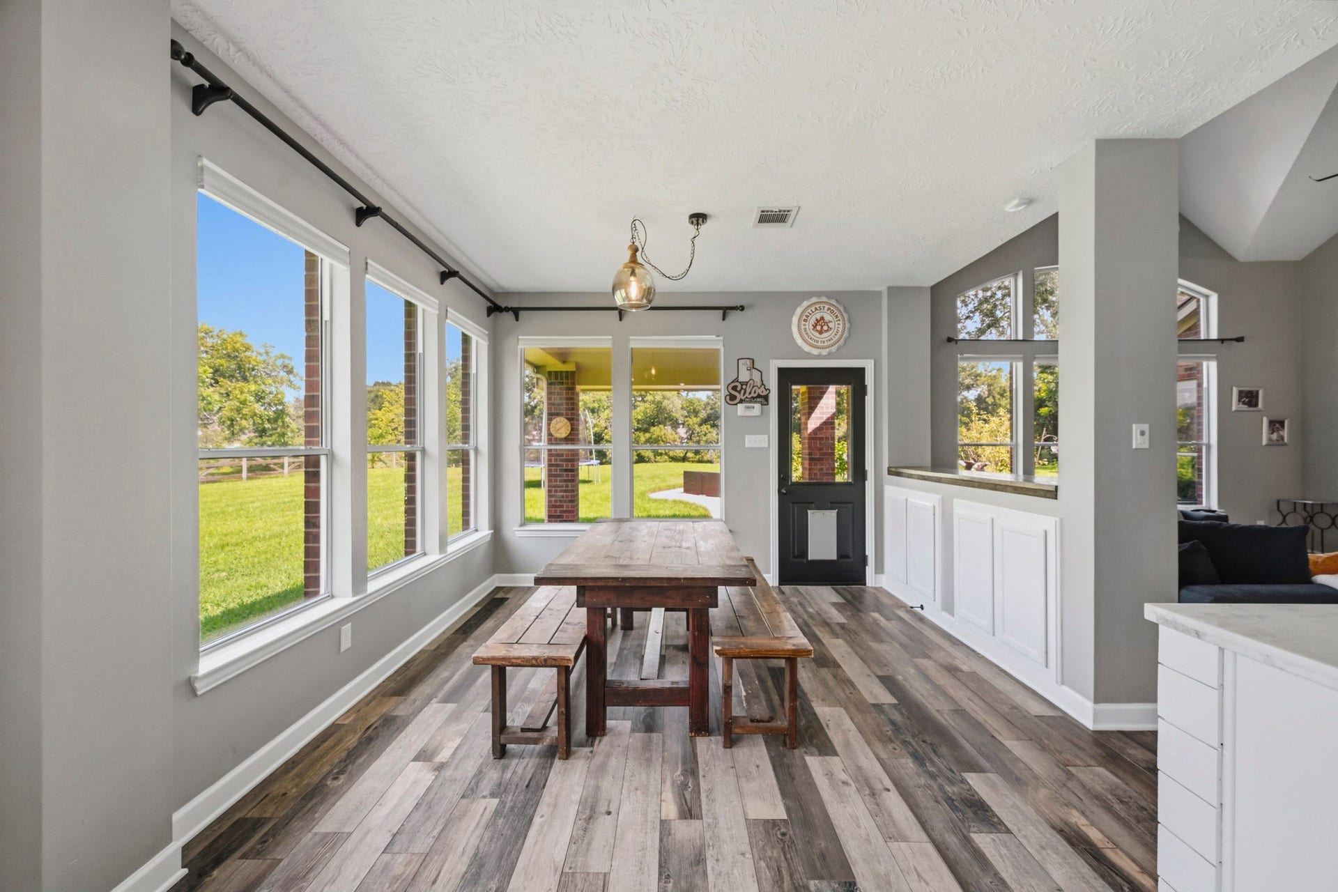 5202 Cherry Ridge Road, Richmond, TX 77406 Bright breakfast room with panoramic backyard views, abundant storage, and custom wood countertops.