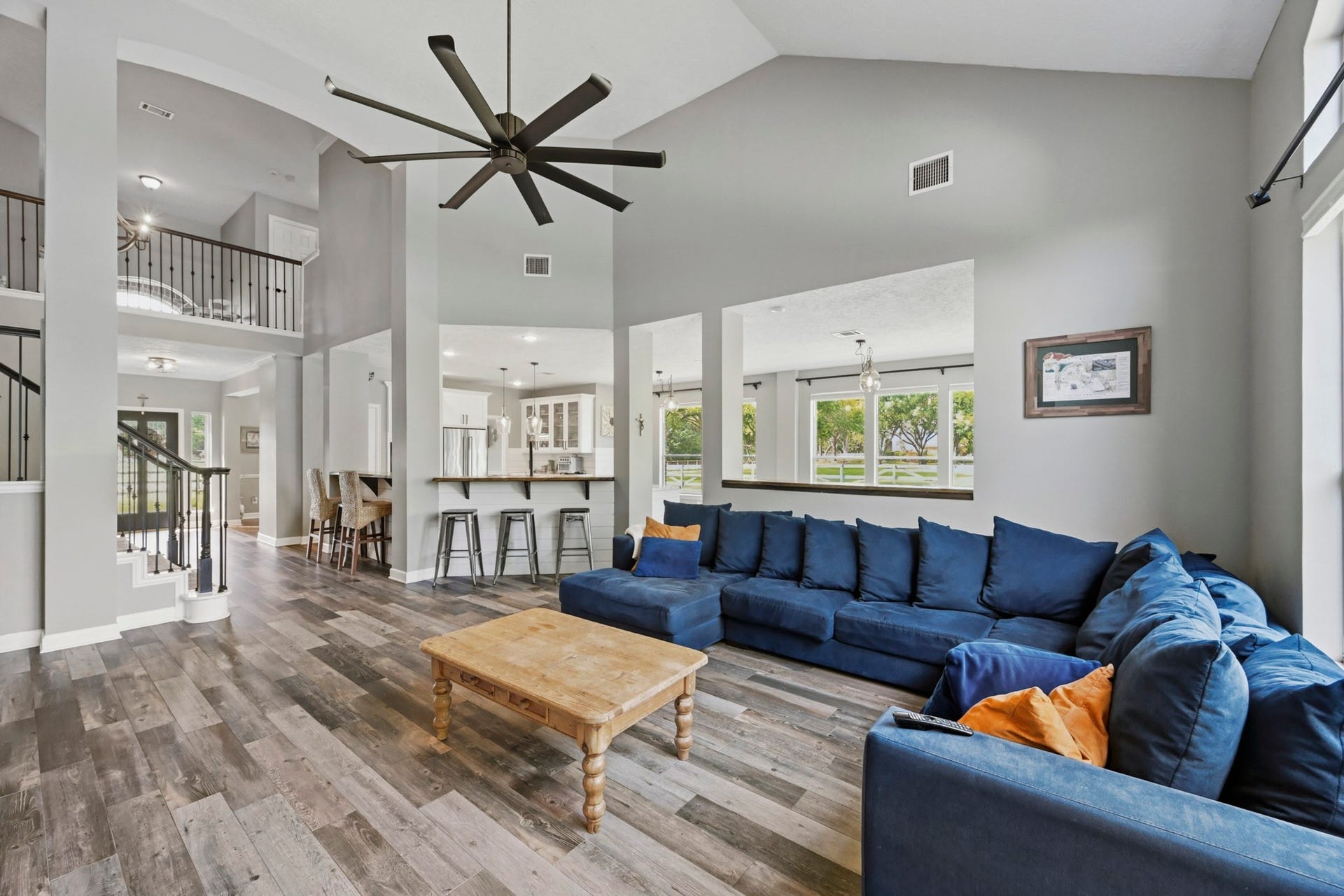 5202 Cherry Ridge Road, Richmond, TX 77406 Open-concept living area featuring the kitchen, breakfast bar, butlers pantry, grand staircase, and beautiful flooring.