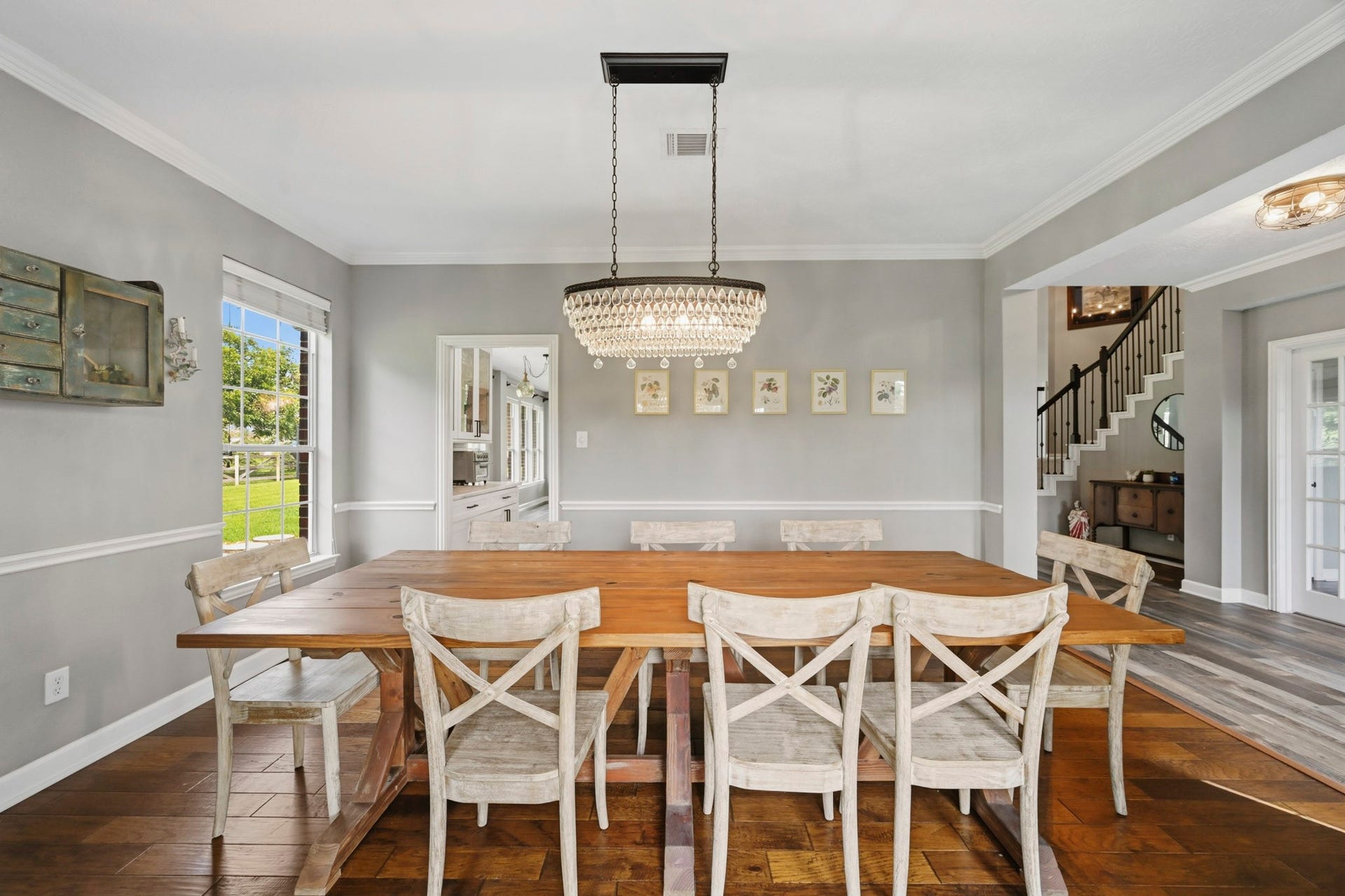 5202 Cherry Ridge Road, Richmond, TX 77406 Formal dining room featuring crown molding, beautiful flooring, abundant natural light, and a statement chandelier.