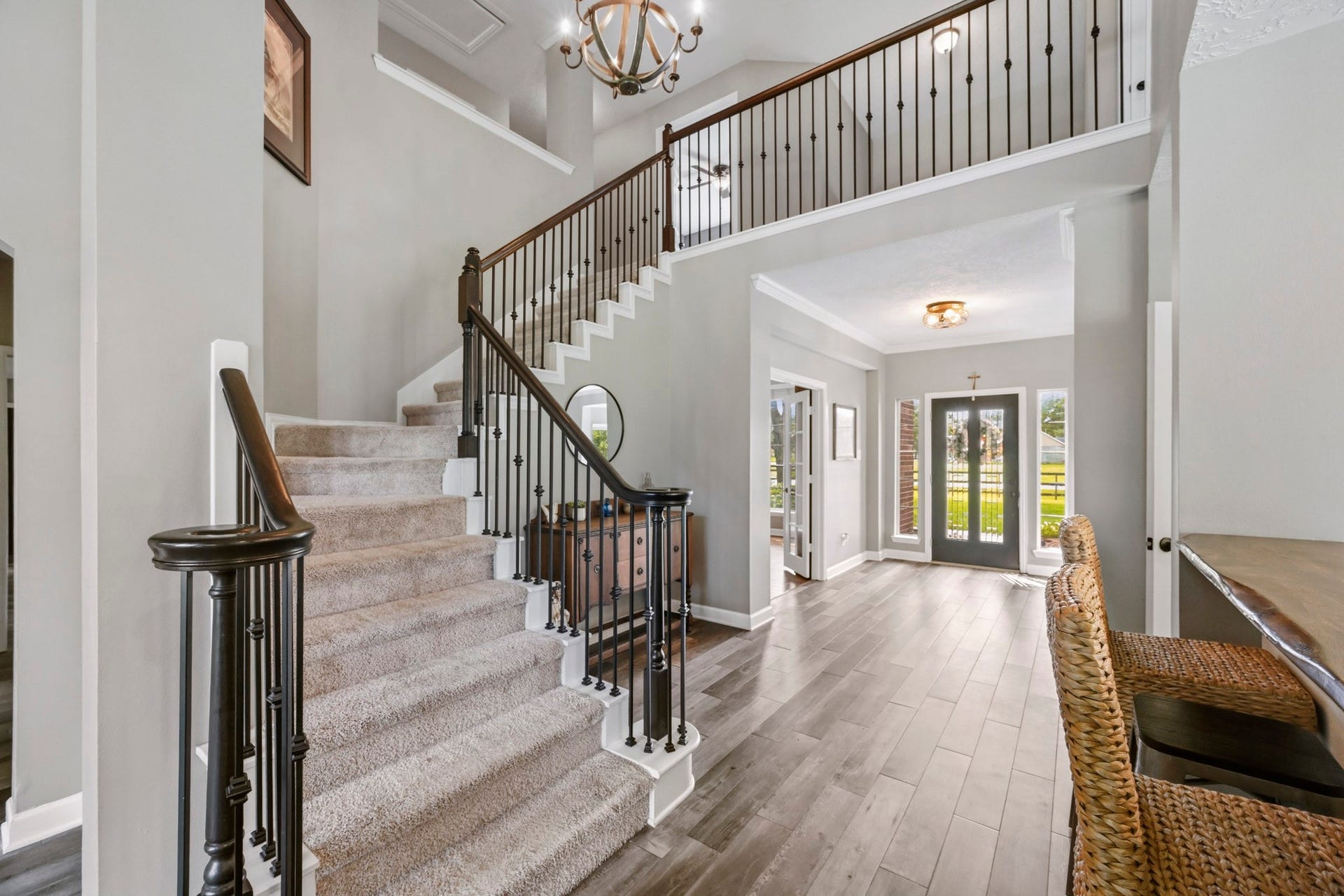 5202 Cherry Ridge Road, Richmond, TX 77406 Grand staircase and welcoming entry with views of the private study behind French doors.