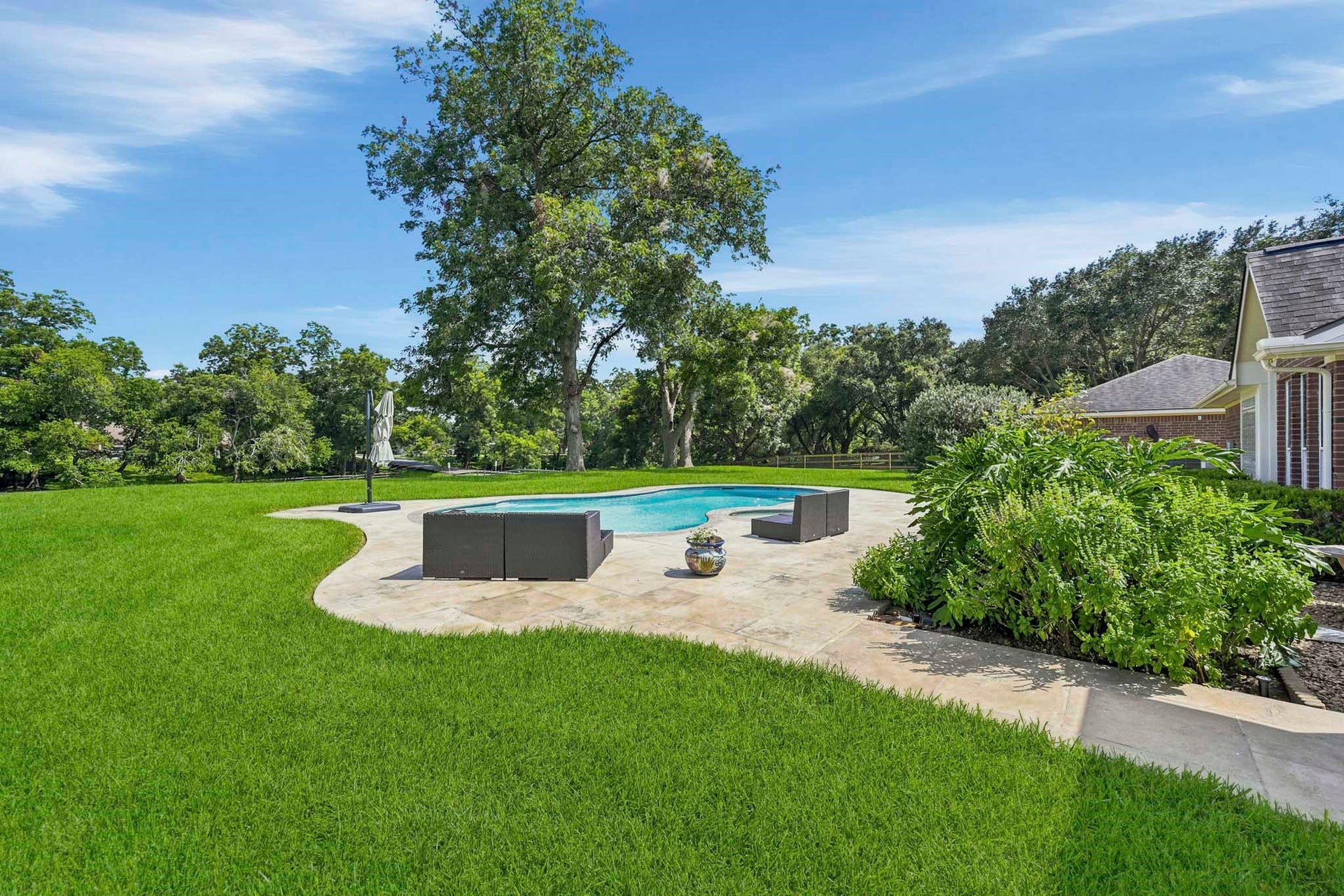 5202 Cherry Ridge Road, Richmond, TX 77406 Resort-style heated pool and spa overlooking the serene, tree-lined backyard.