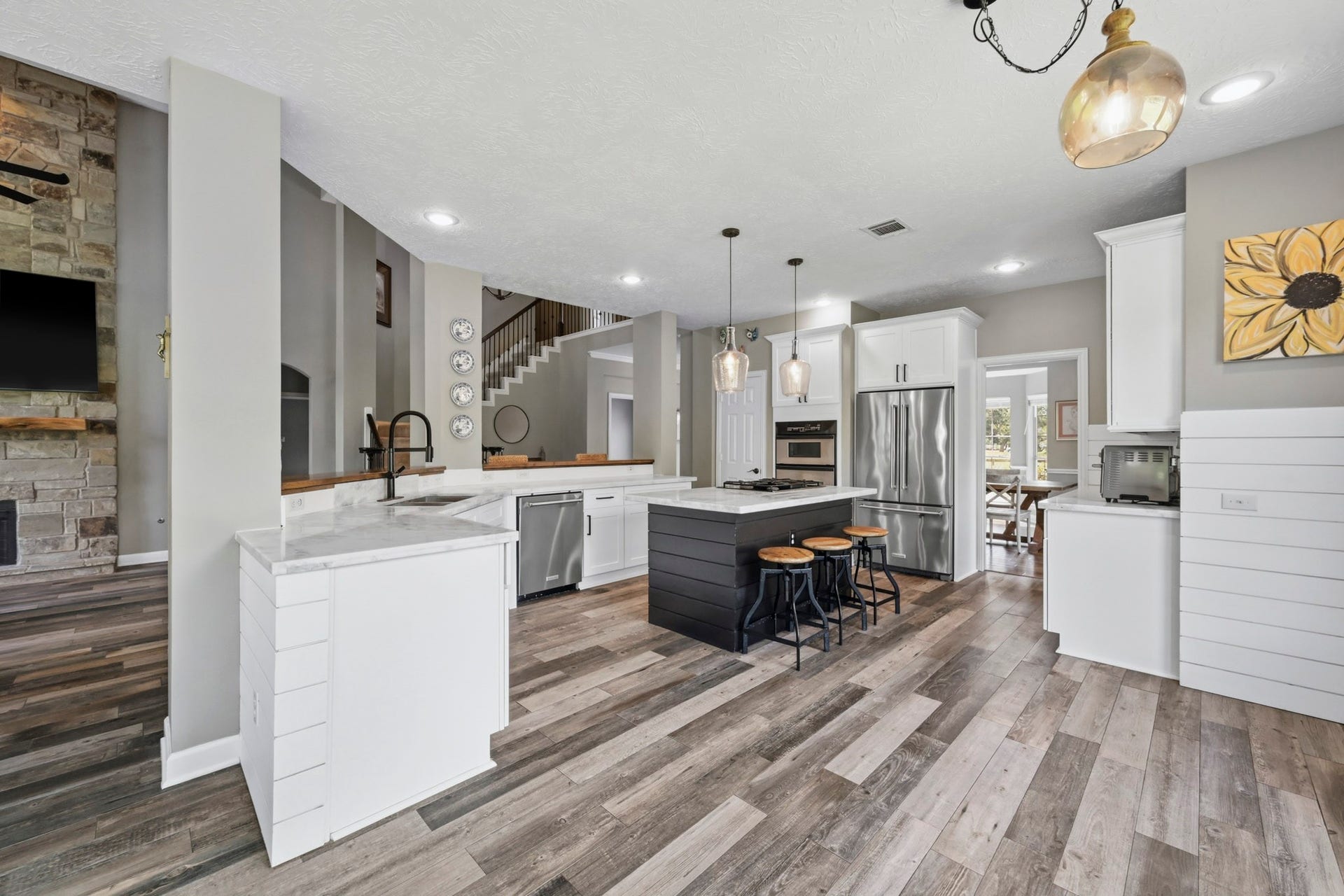 5202 Cherry Ridge Road, Richmond, TX 77406 Chef-inspired kitchen showcasing elegant marble countertops and abundant cabinetry. View of Open kitchen which lends itself to leisurely entertainment w/beautiful Marble countertops, sit up island, stainless appliances, butler's pantry, convection oven, lots of natural sunlight