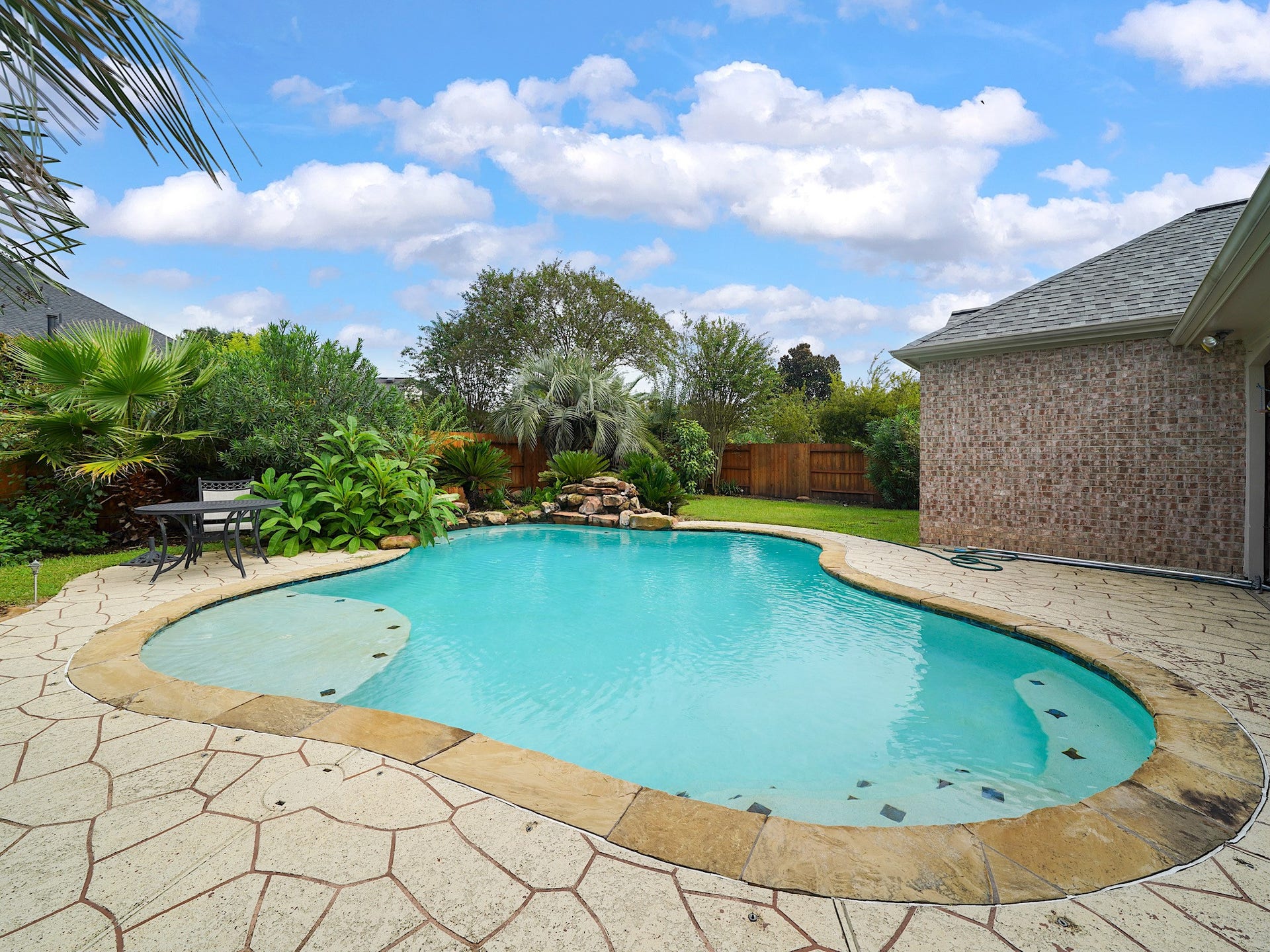A second view reveals the pools inviting curves and leafy backdrop, offering an easy escape just outside your door.