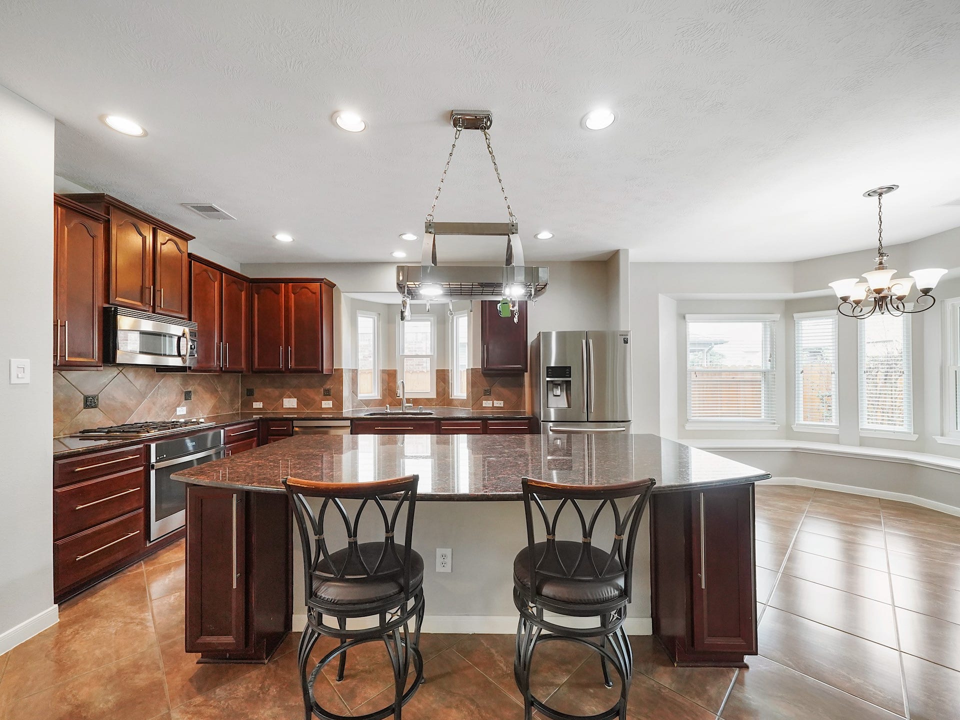The island creates a natural gathering place for quick mornings, homework, or guests keeping the cook company.