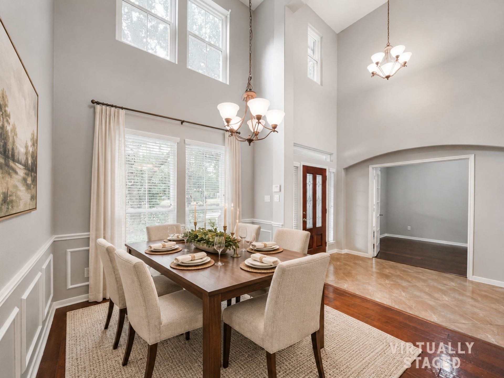 Virtually staged: Soaring ceilings, tall windows, and detailed paneling give the formal dining room an elegant backdrop for celebrations and lingering dinners.