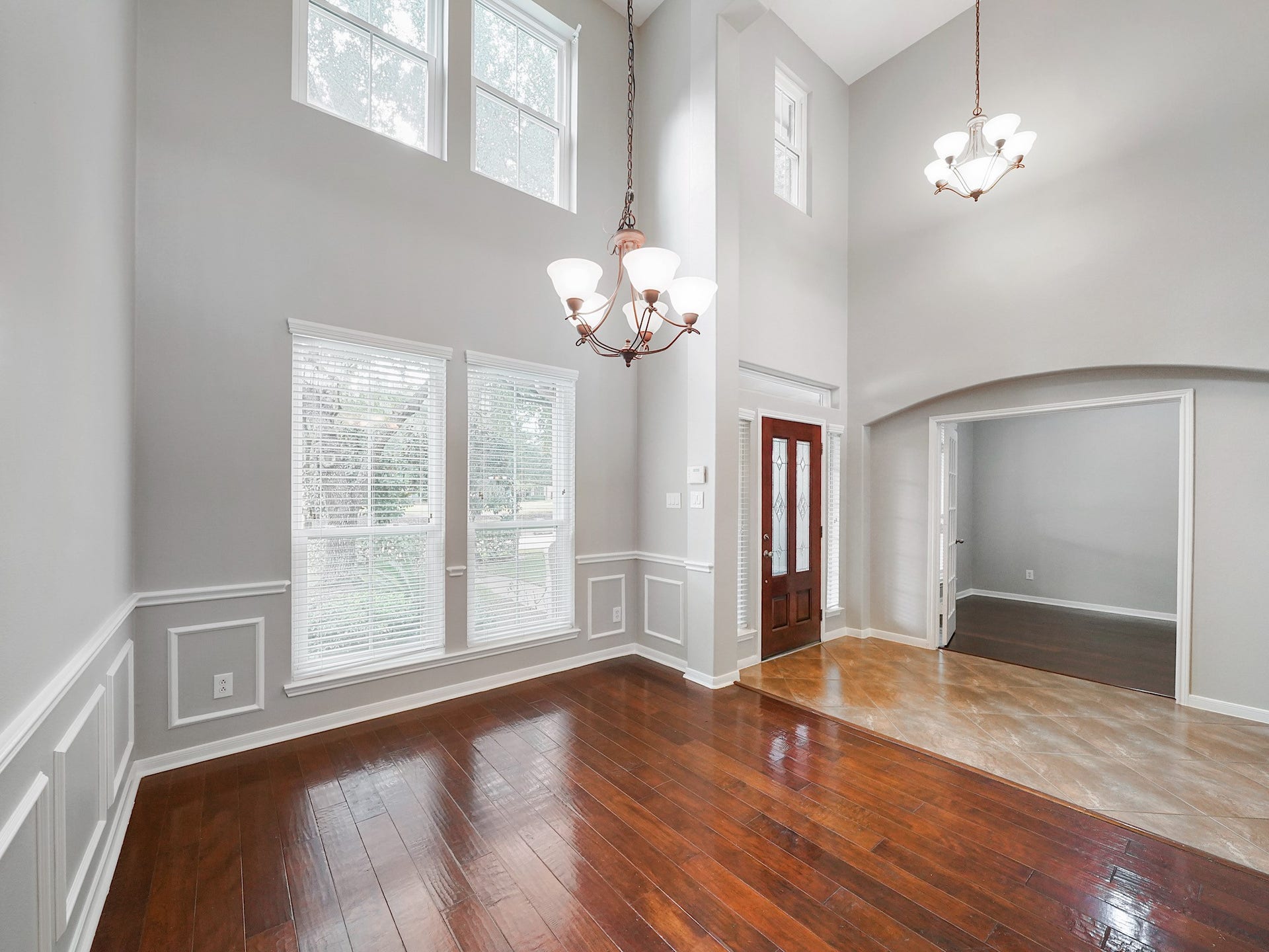 A second view highlights the formal dining rooms impressive scale, natural light, and seamless connection to the entry.