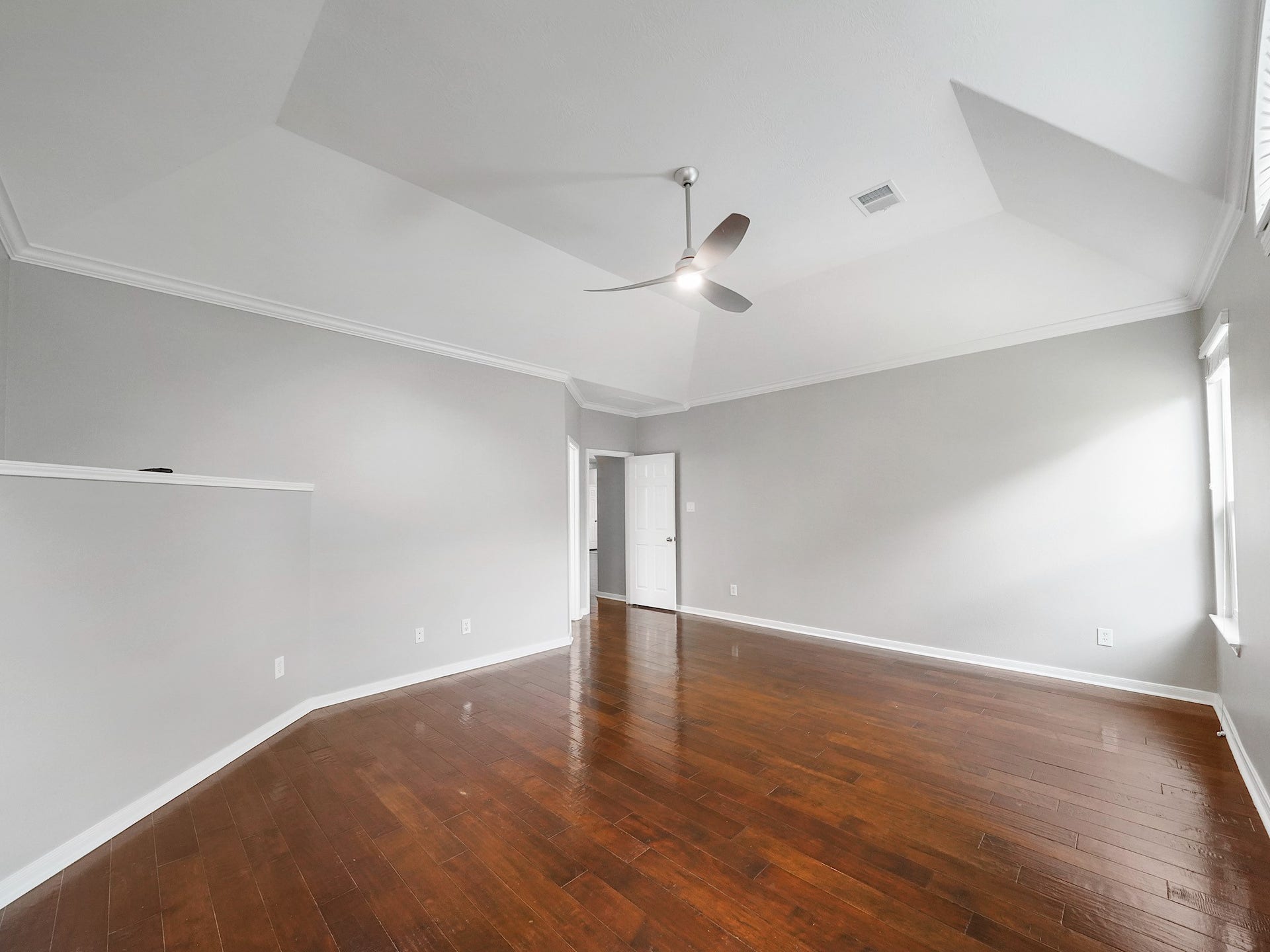 Another angle captures the expansive primary suite, freshly painted and seamlessly connected to the ensuite bath.