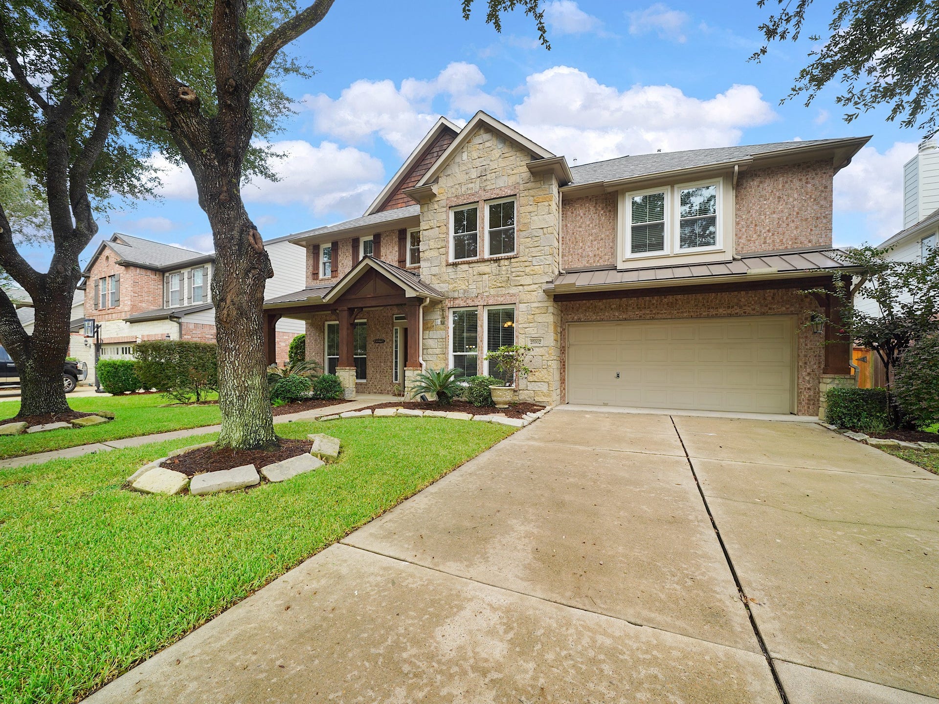 A wide drive, manicured lawn, and handsome exterior details create a welcoming first impression.