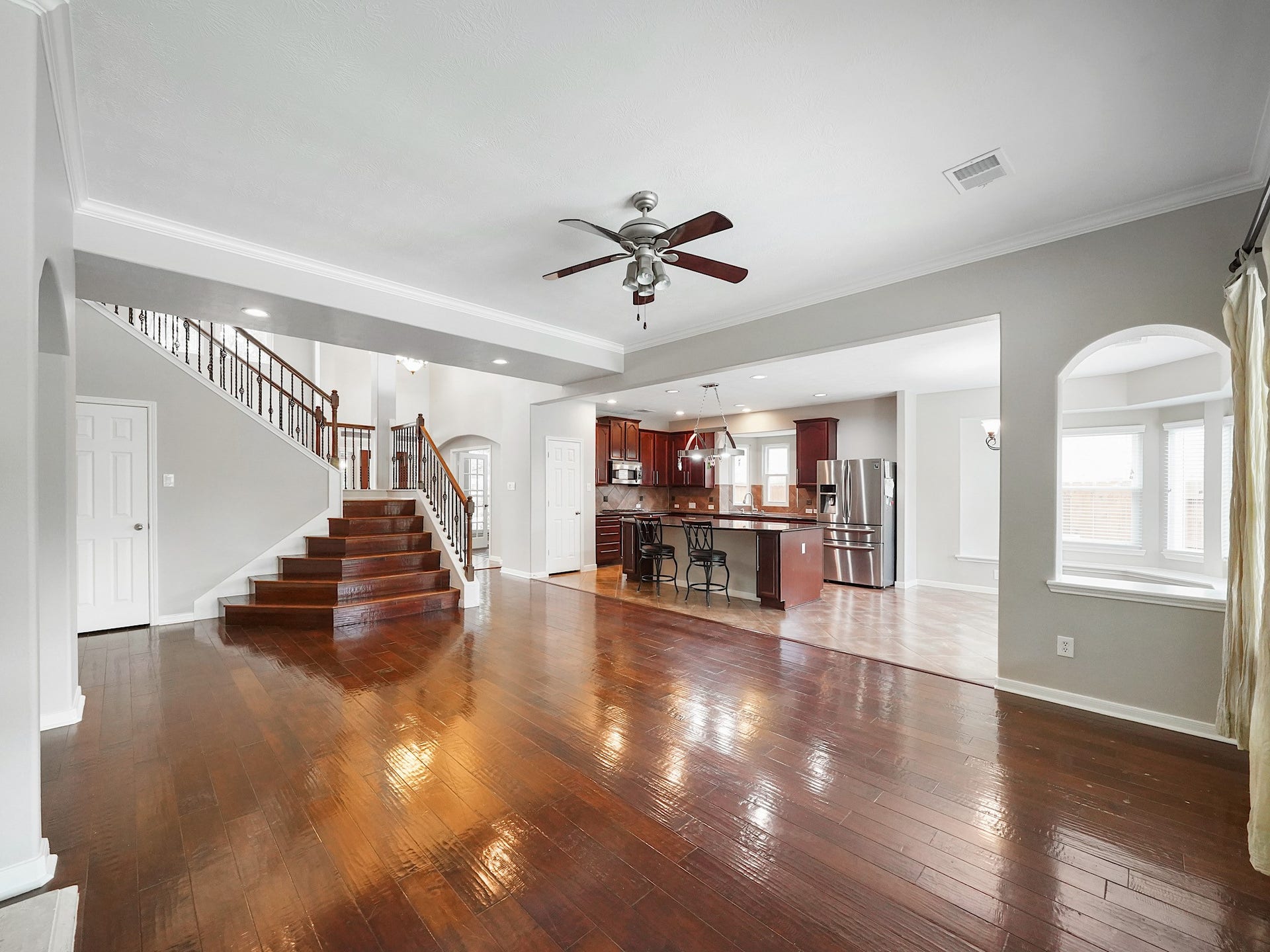 Fresh paint, expansive wood floors, and abundant natural light give the main living space an airy, welcoming feel.
