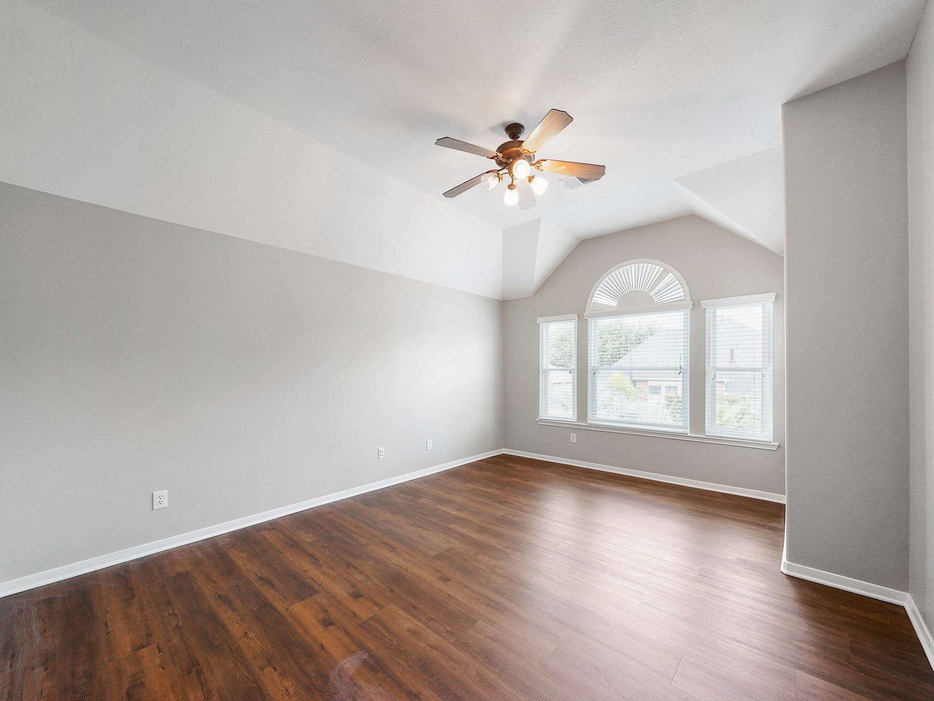 The media rooms pitched ceiling and distinctive arched window bring character and natural light to an otherwise flexible entertaining space.