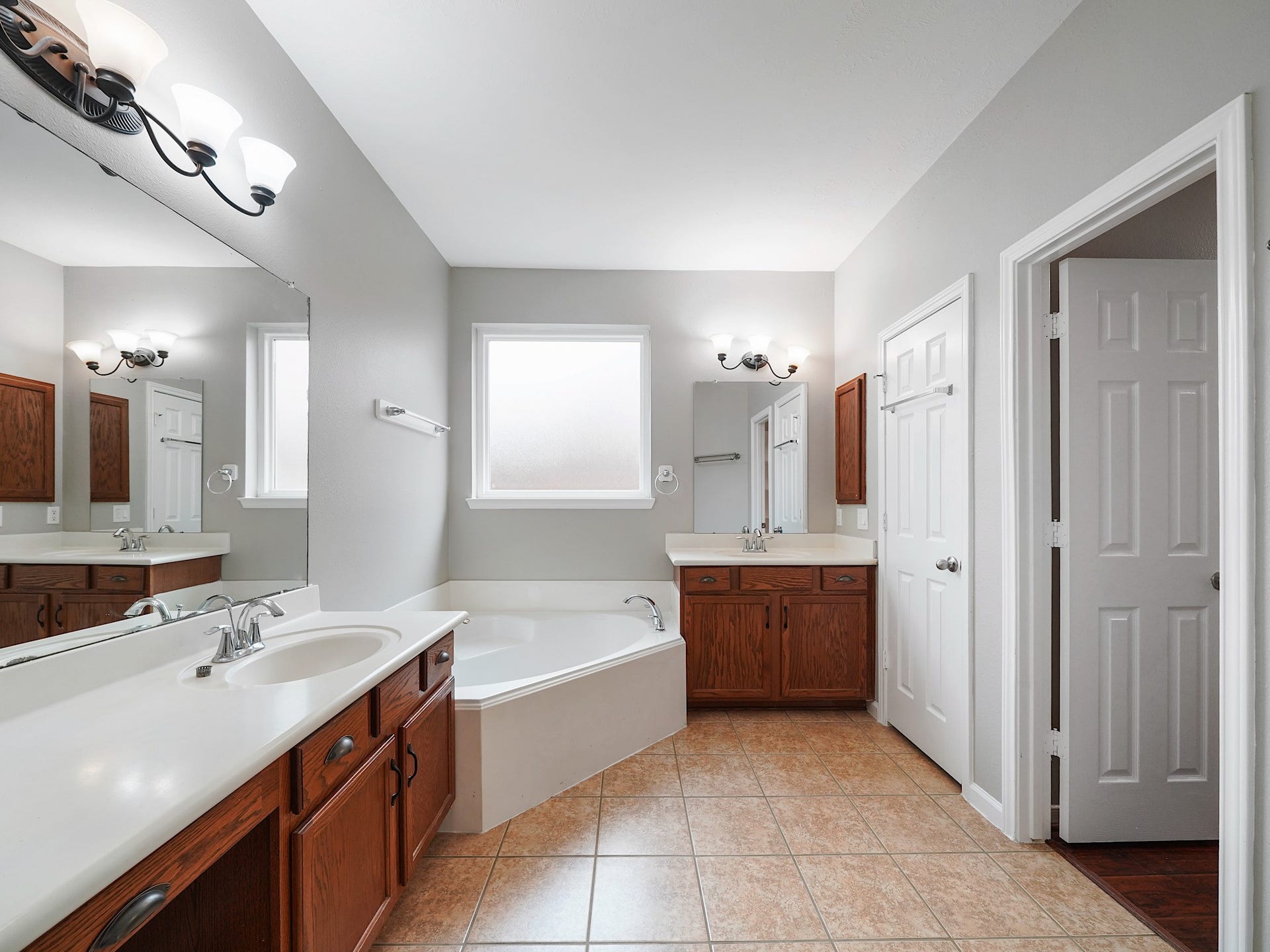 The primary bath offers a relaxing layout with a soaking tub, generous vanity space, and room to begin or end the day with ease.