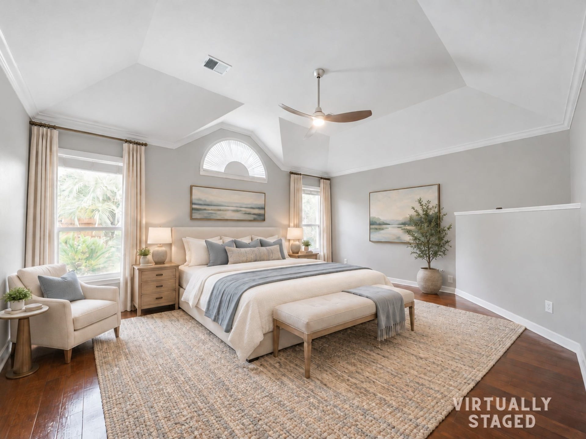 Virtually staged: The primary retreat pairs a striking vaulted ceiling and arched window with rich wood floors and a comfortable layout for rest and relaxation.