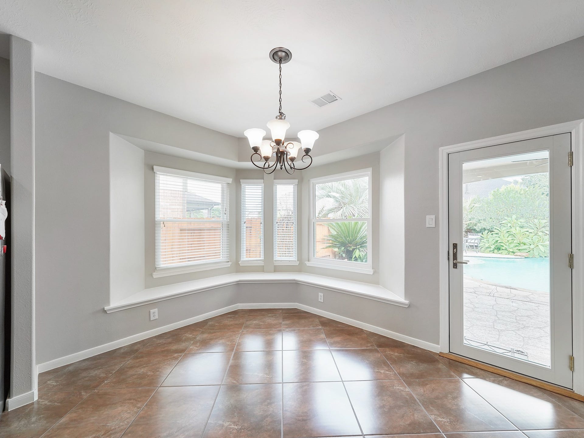 Surrounded by windows, the breakfast area brings in beautiful natural light for relaxed meals throughout the day.