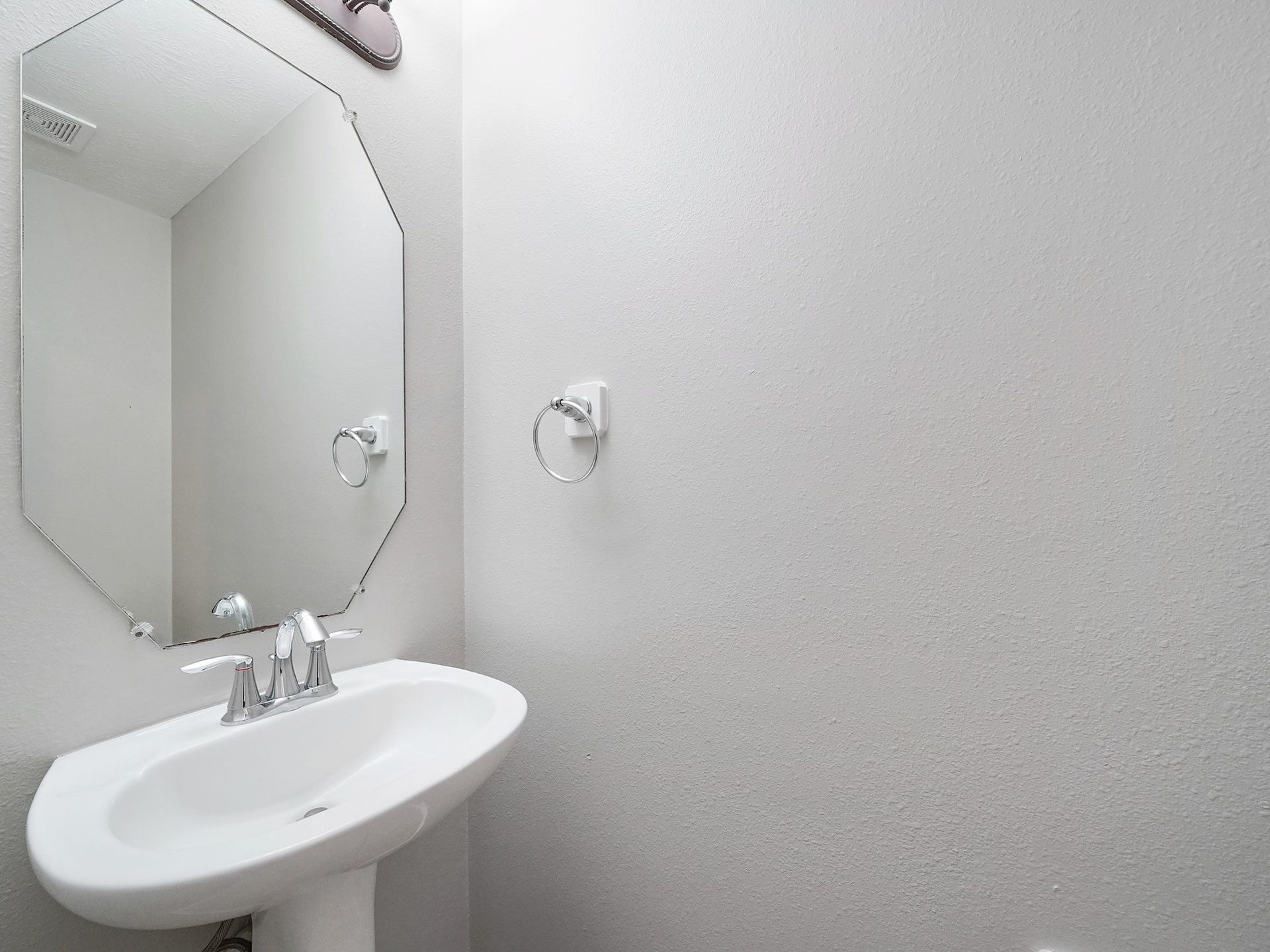 A conveniently located powder bath serves guests and the downstairs gathering spaces.