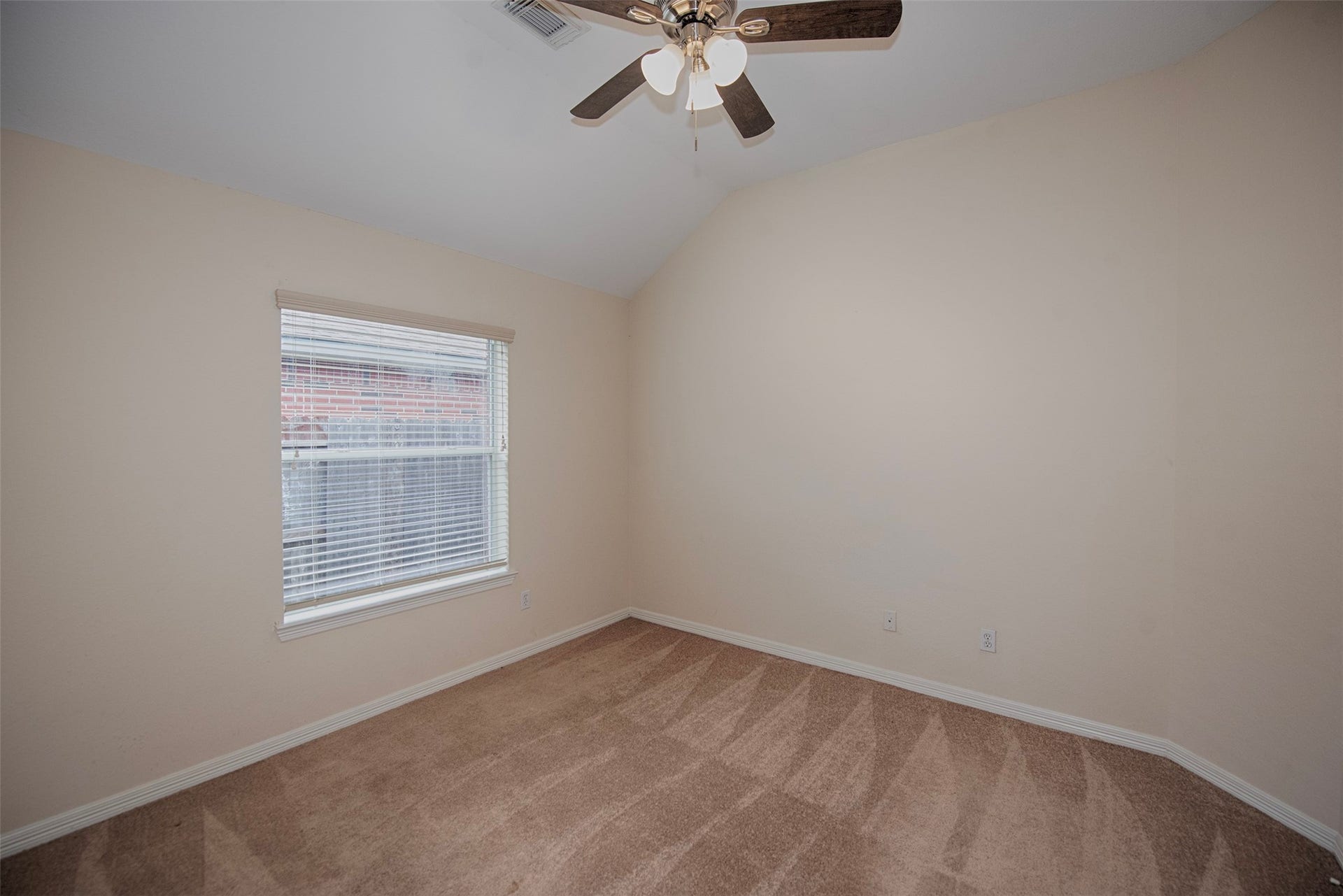 One of the additional bedrooms with vaulted ceiling. Terrific space.
