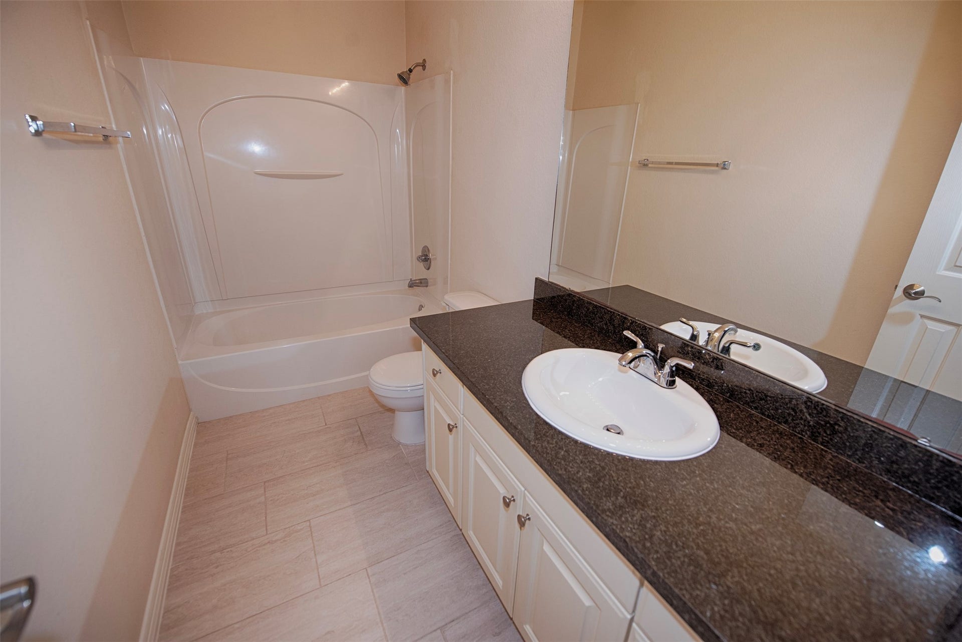 The additional bathroom with huge vanity and combo bath and shower. Perfect for sharing.