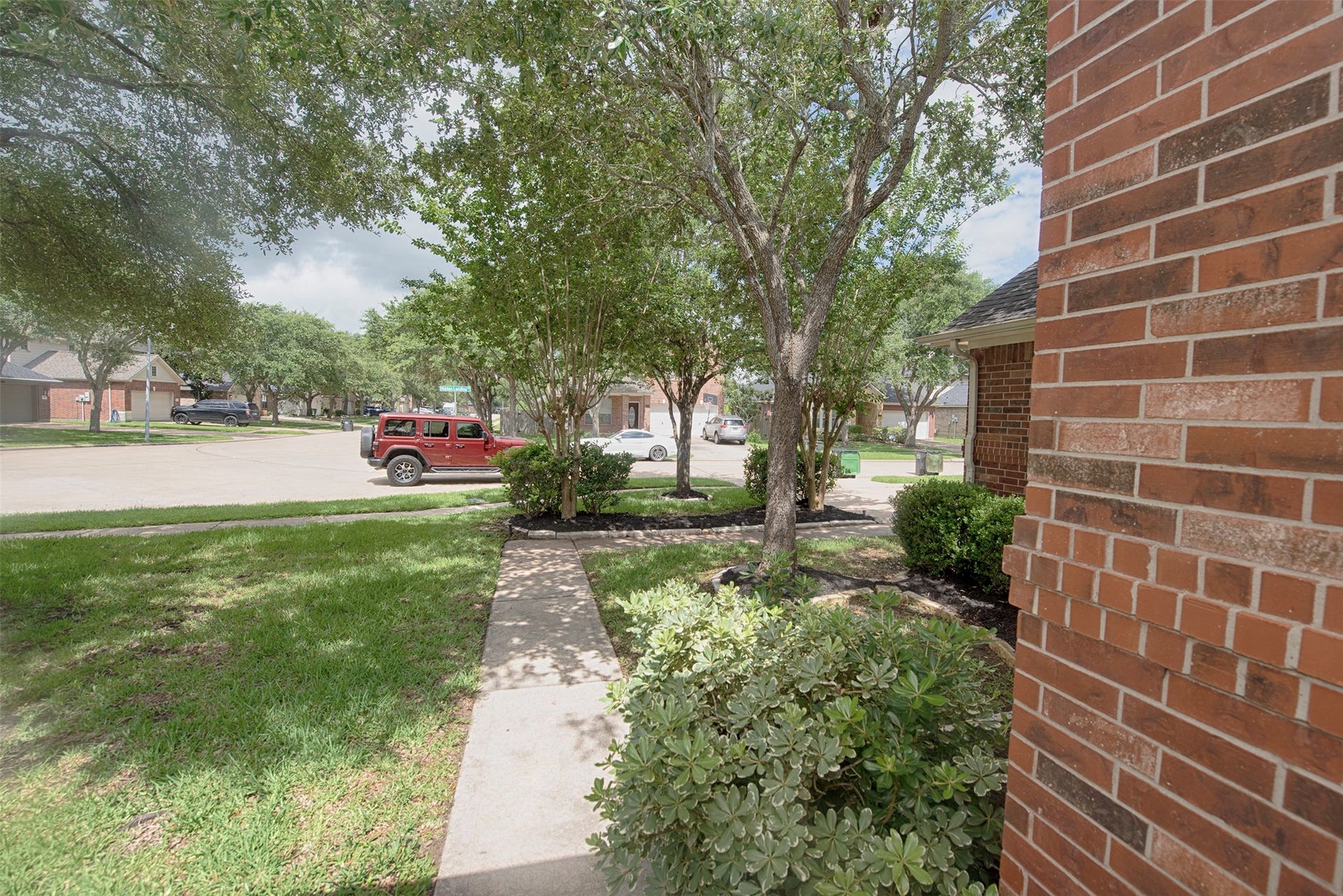 A view of the front yard from the porch. Home is located on a quiet cul-de-sac.