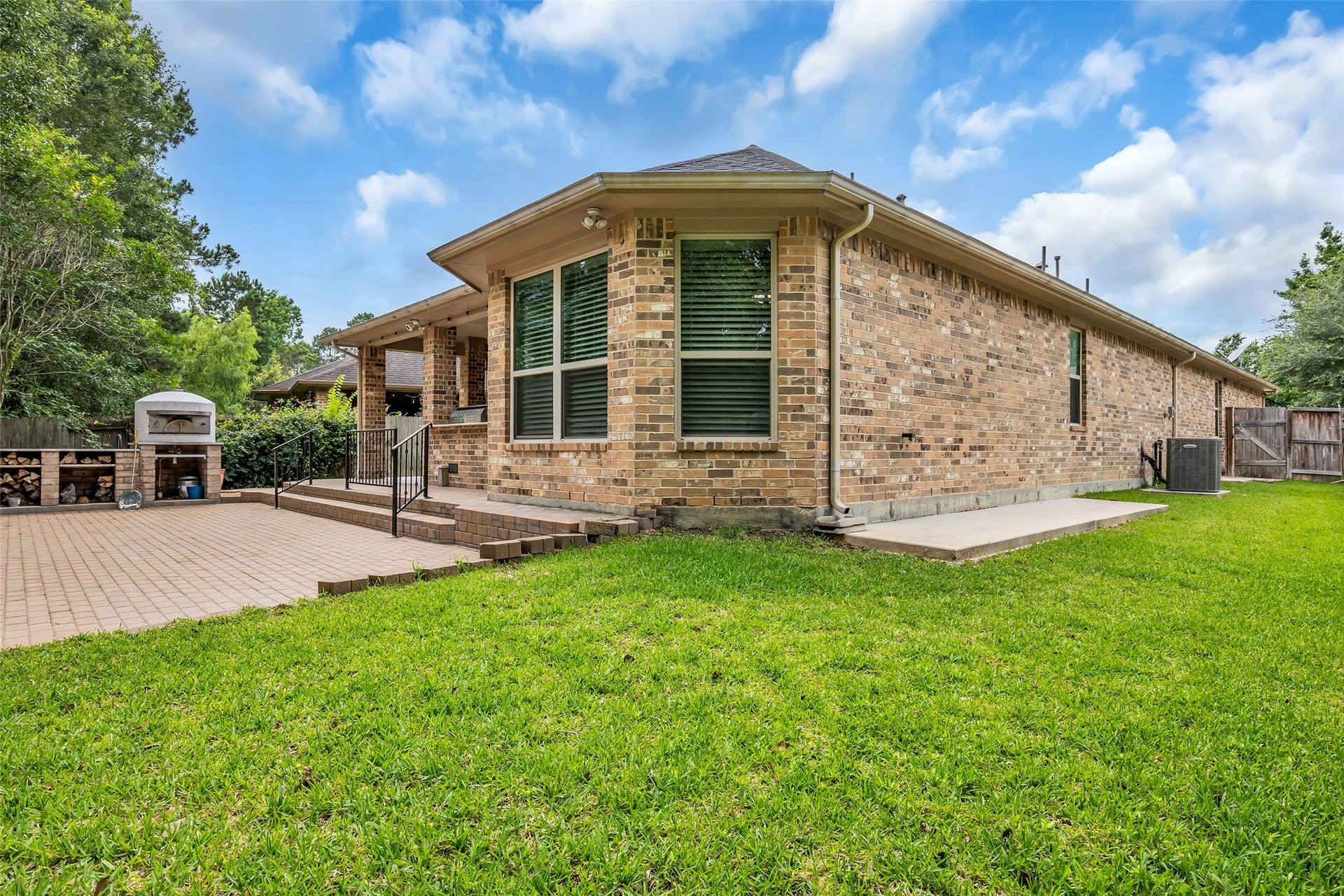Concrete walkways on both sides of the brick home