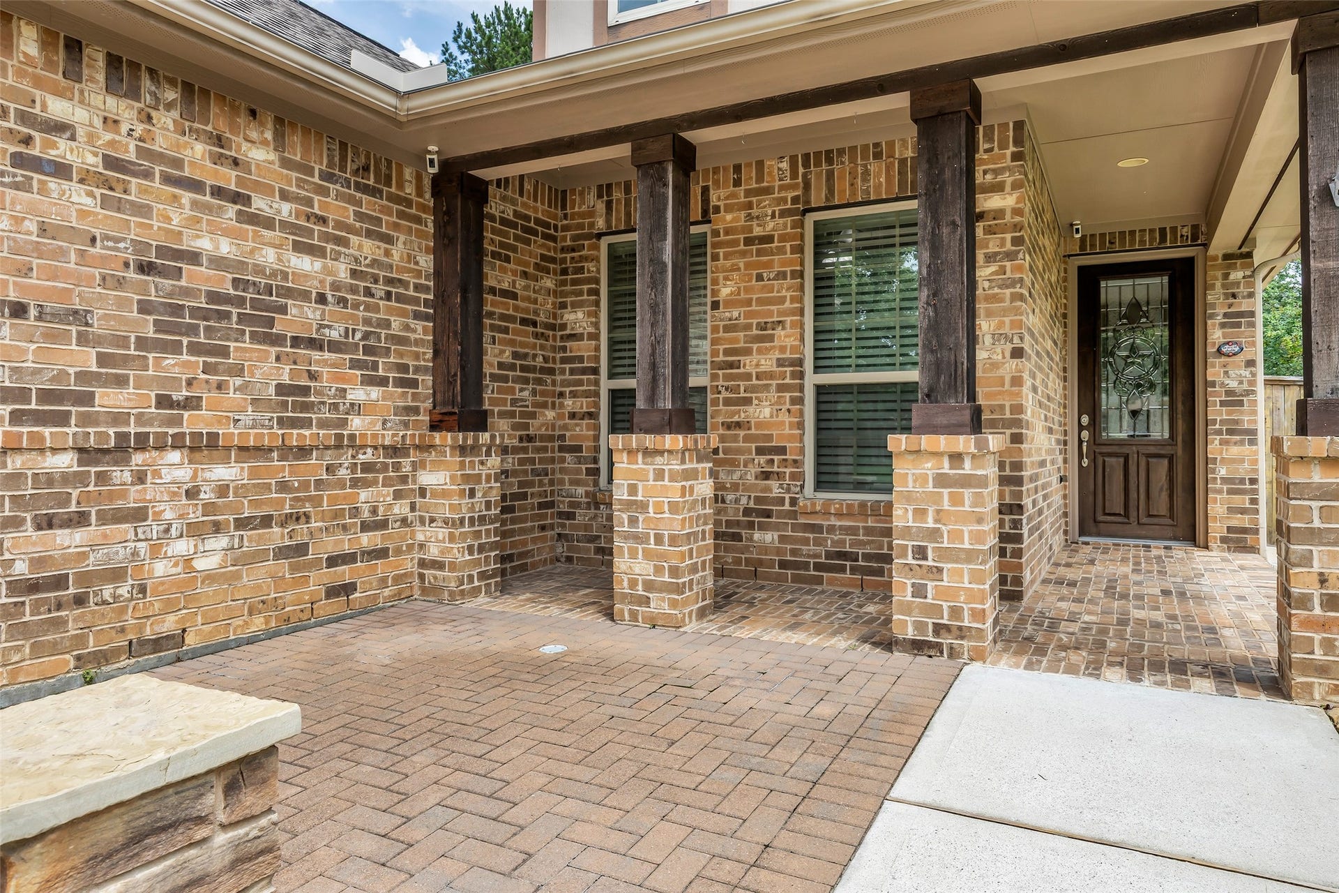 Brick paver courtyard and covered patio.