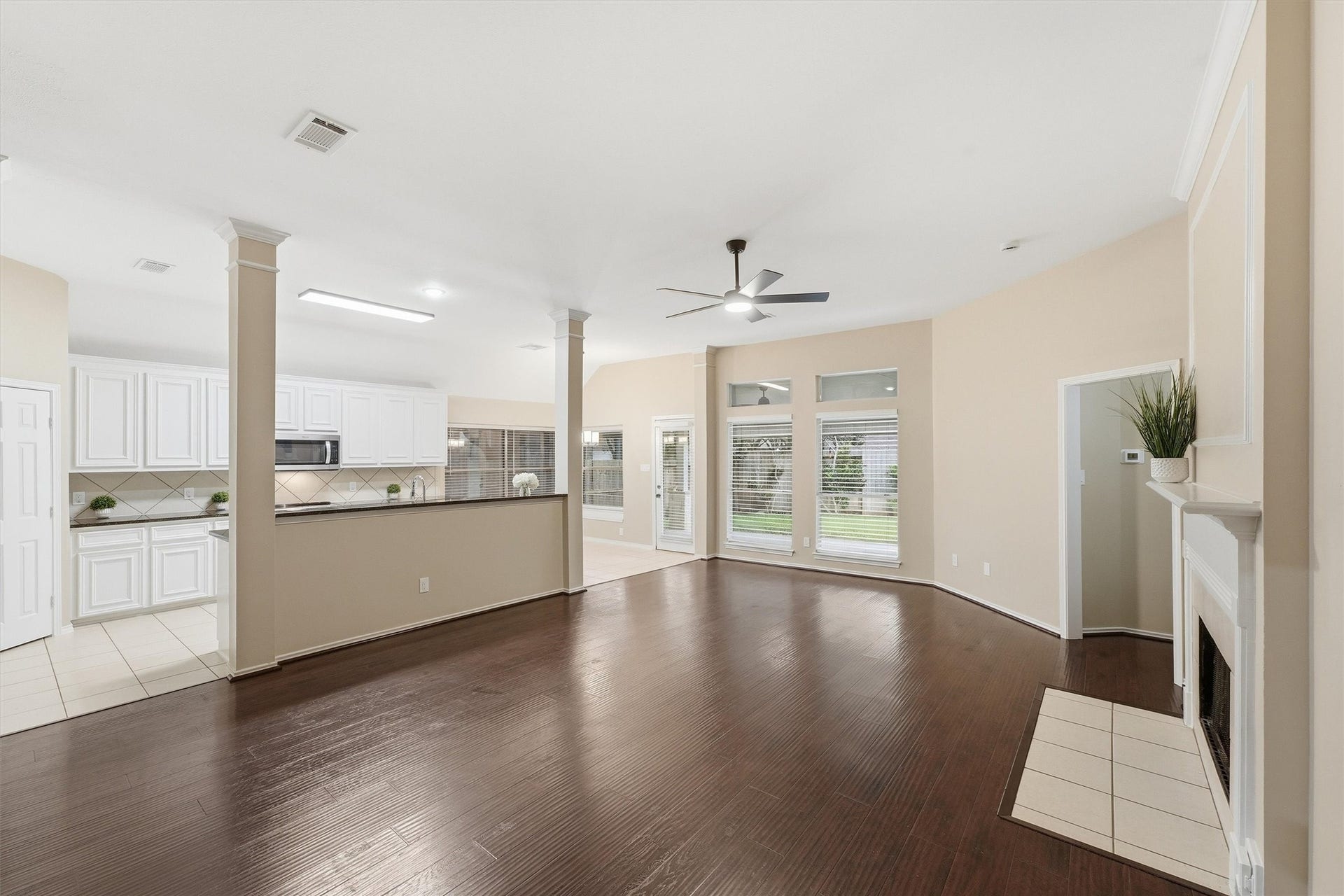 Wide-angle view of the open-concept living room, highlighting the seamless flow into the kitchen and dining areas.