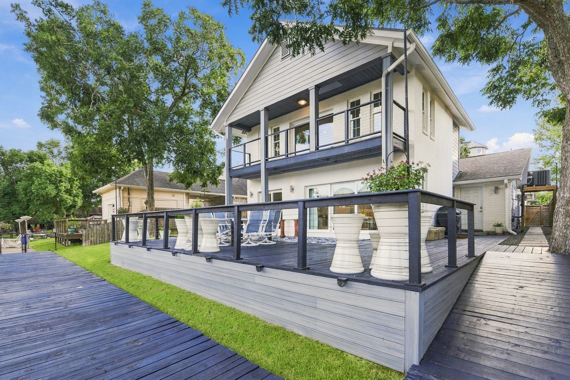 14 Harbor Lane, Kemah, TX 77565 This inviting back porch is calling for your entertaining guests.