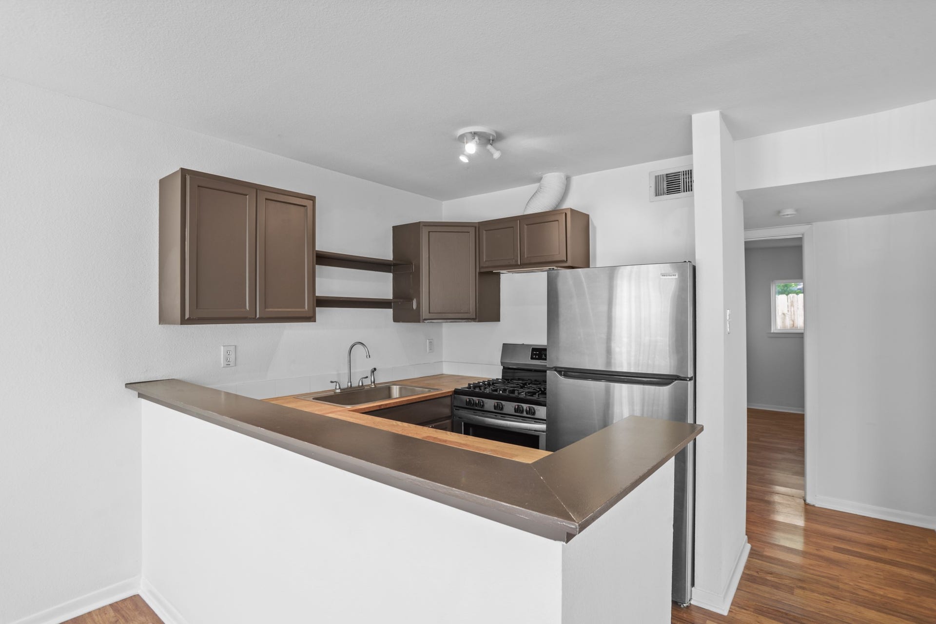 Recently updated kitchen includes cabinetry, stainless steel appliances including a dishwasher.