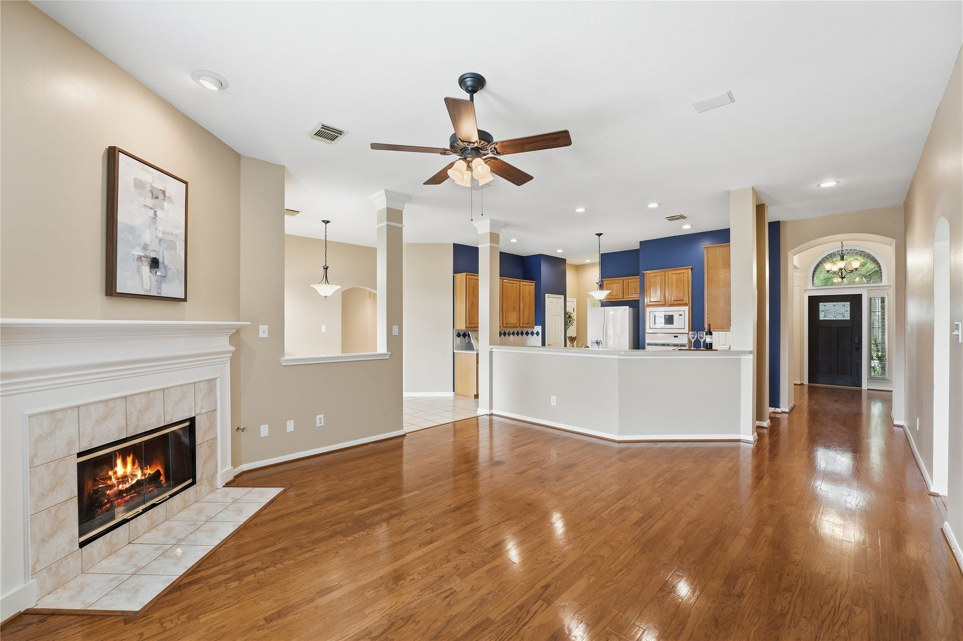 8027 Summer Brook Court, Sugar Land, TX 77479 A view back towards the entry shows the open concept den, kitchen, and breakfast room.