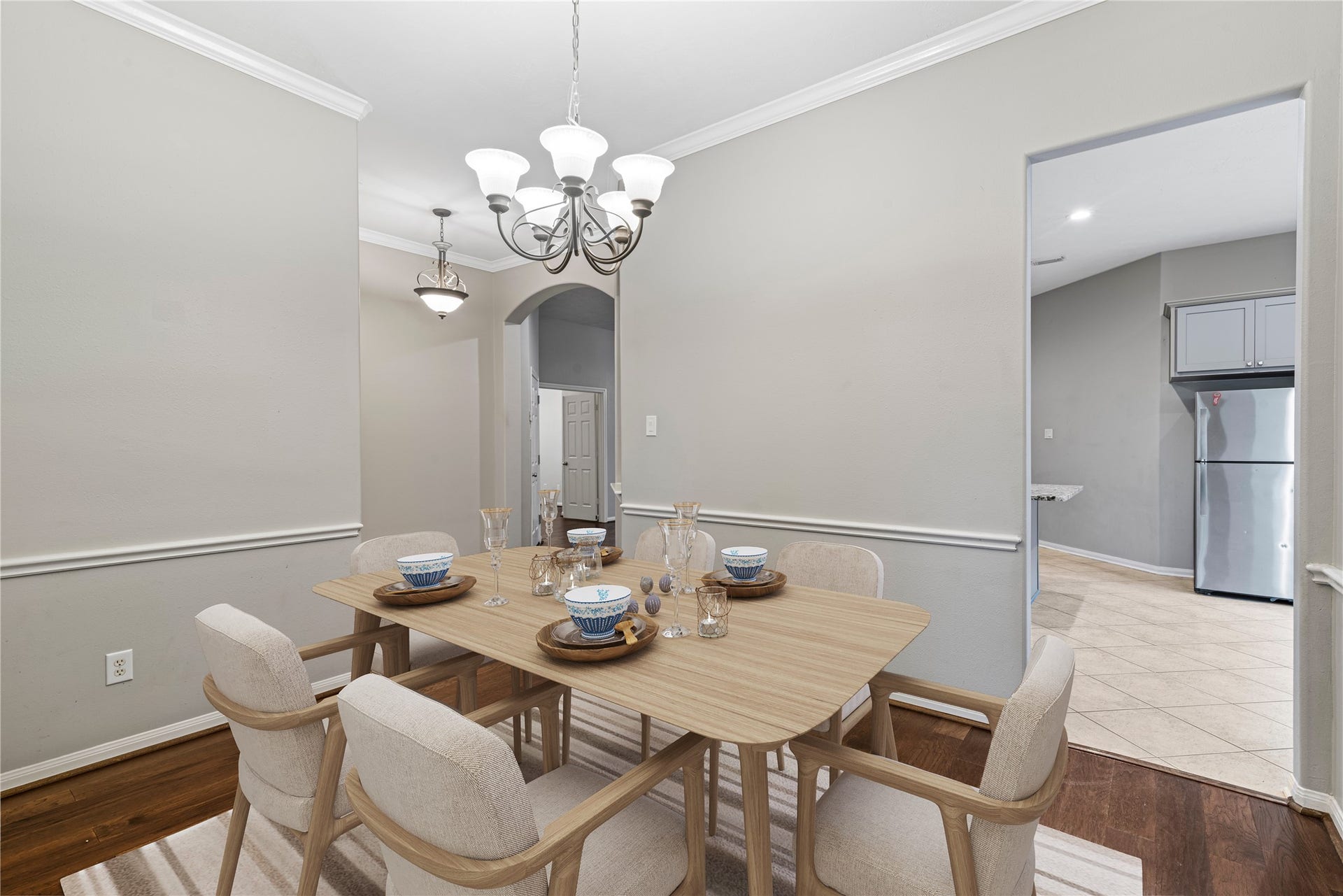 66 Bryce Branch Circle, Spring, TX 77382 Virtually Staged: Elegant dining area with soft neutral tones, featuring seamless flow into the kitchen.