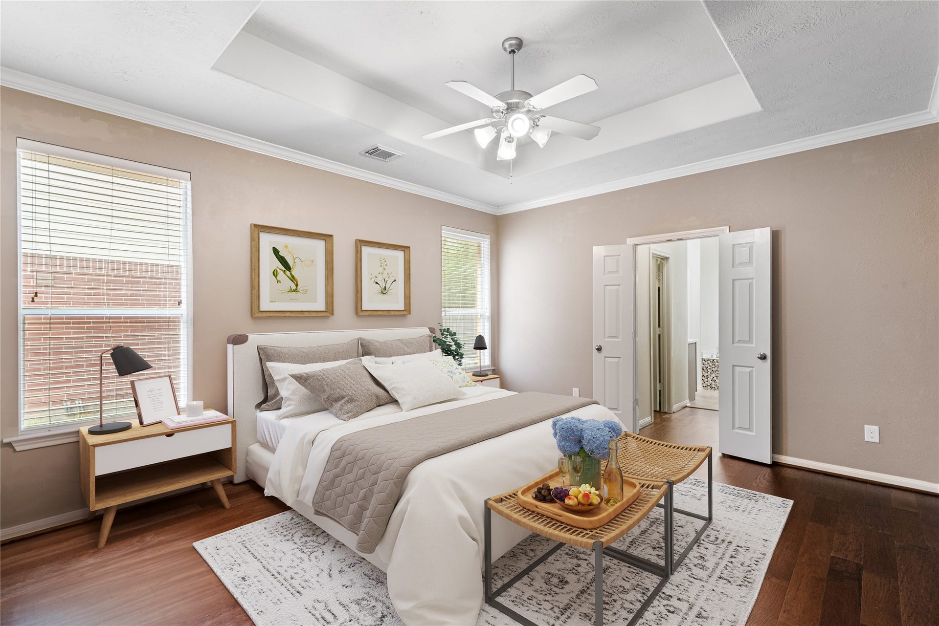 66 Bryce Branch Circle, Spring, TX 77382 Virtually Staged: Spacious master bedroom with elegant tray ceiling, natural light from large windows and neutral colors.