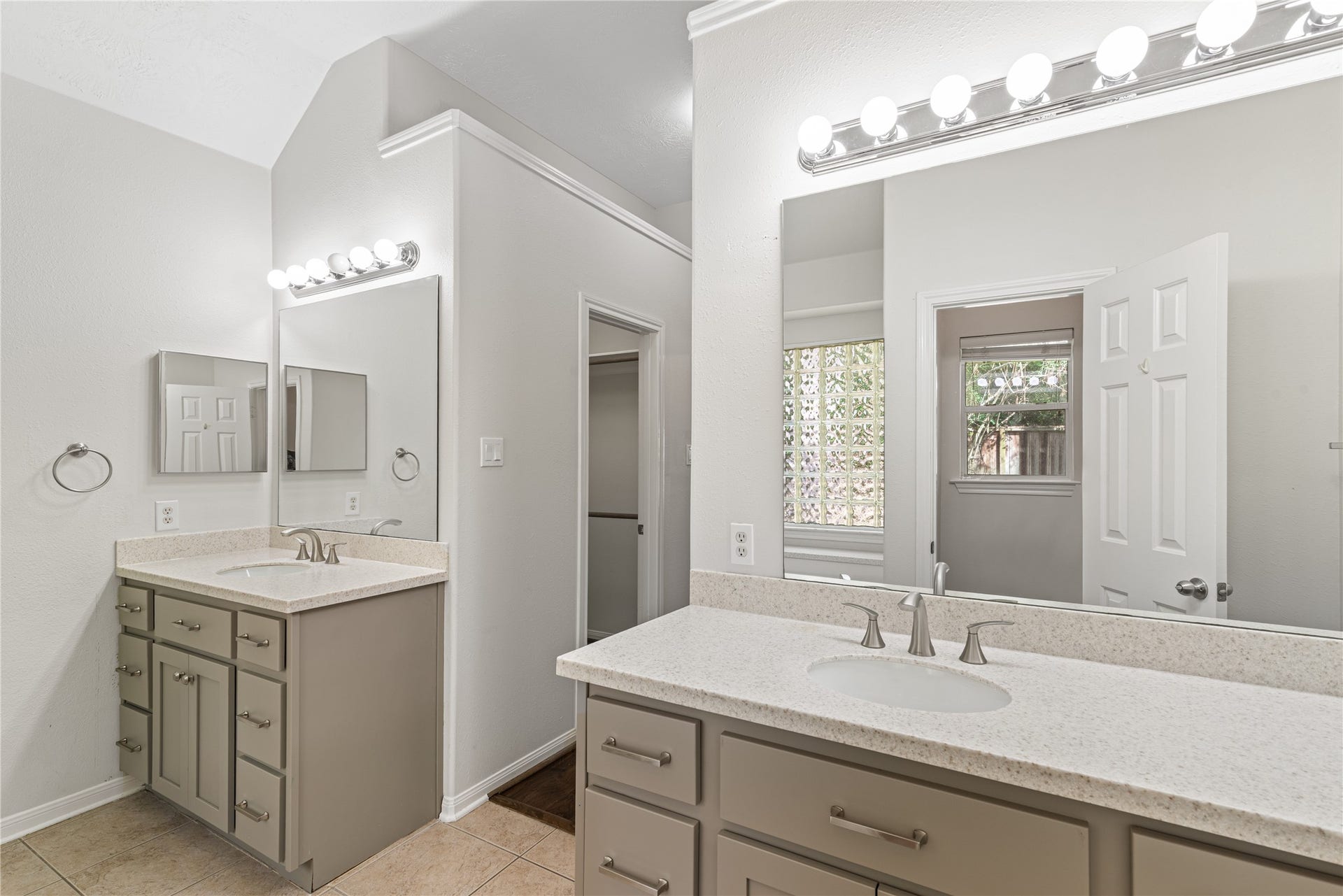 66 Bryce Branch Circle, Spring, TX 77382 Spacious master bathroom featuring dual vanities with ample storage and modern fixtures, complemented by bright overhead lighting and a large mirror.