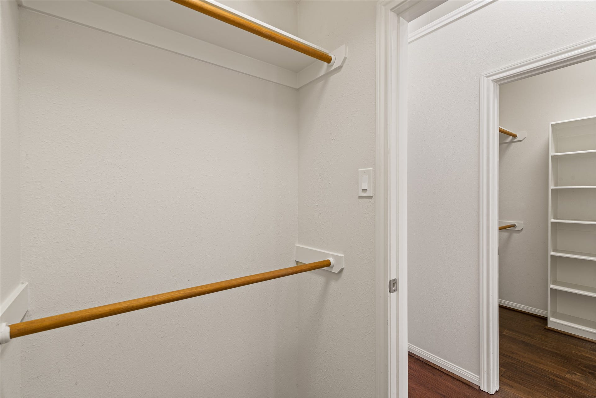 66 Bryce Branch Circle, Spring, TX 77382 1st walk-in closet with ample hanging rods and shelving, offering organized storage solutions.