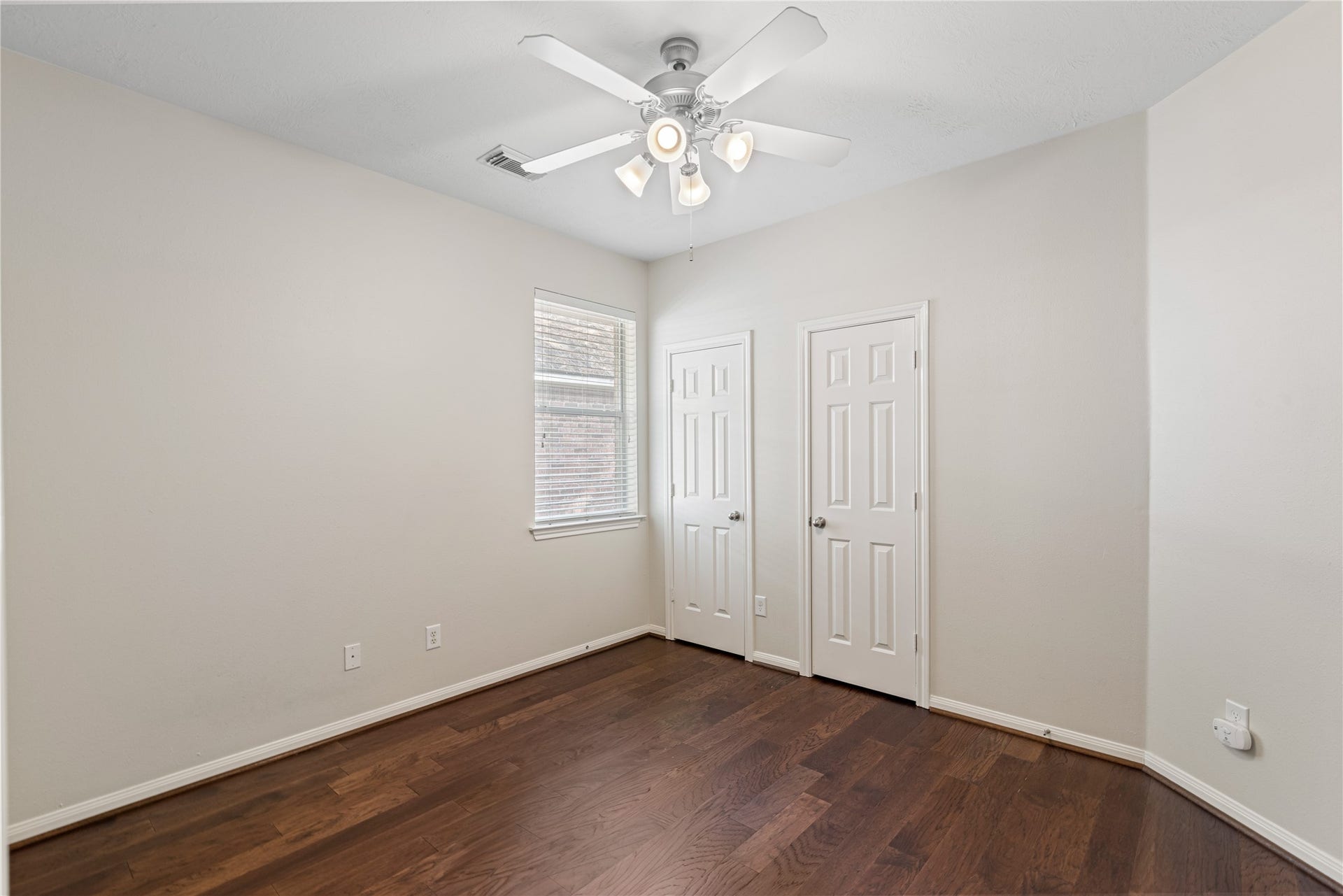 66 Bryce Branch Circle, Spring, TX 77382 2nd bedroom is bright and inviting with a ceiling fan for comfort, and dual closet doors for ample storage.