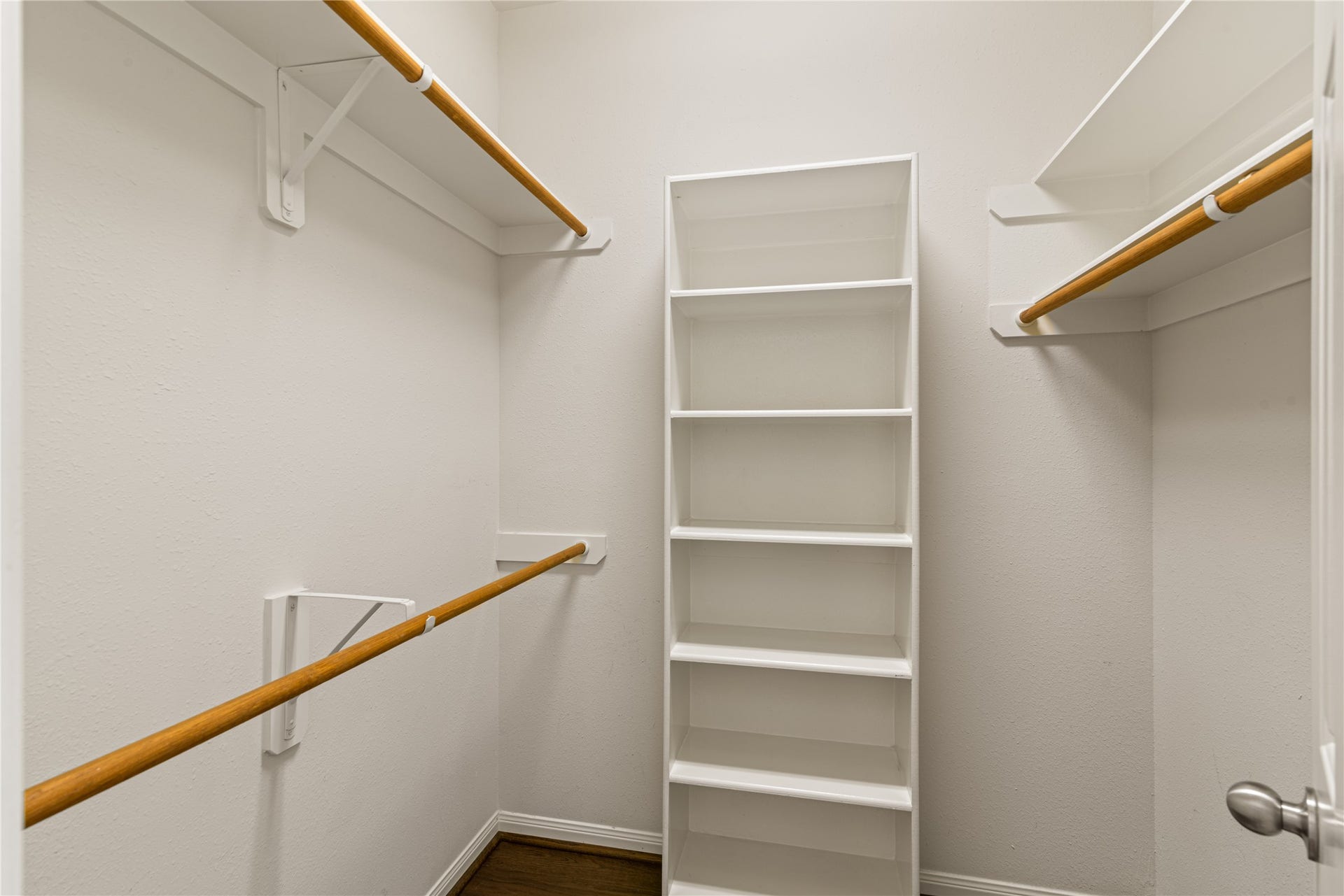 66 Bryce Branch Circle, Spring, TX 77382 2nd master walk-in closet featuring ample hanging rods and built-in shelving for organized storage.