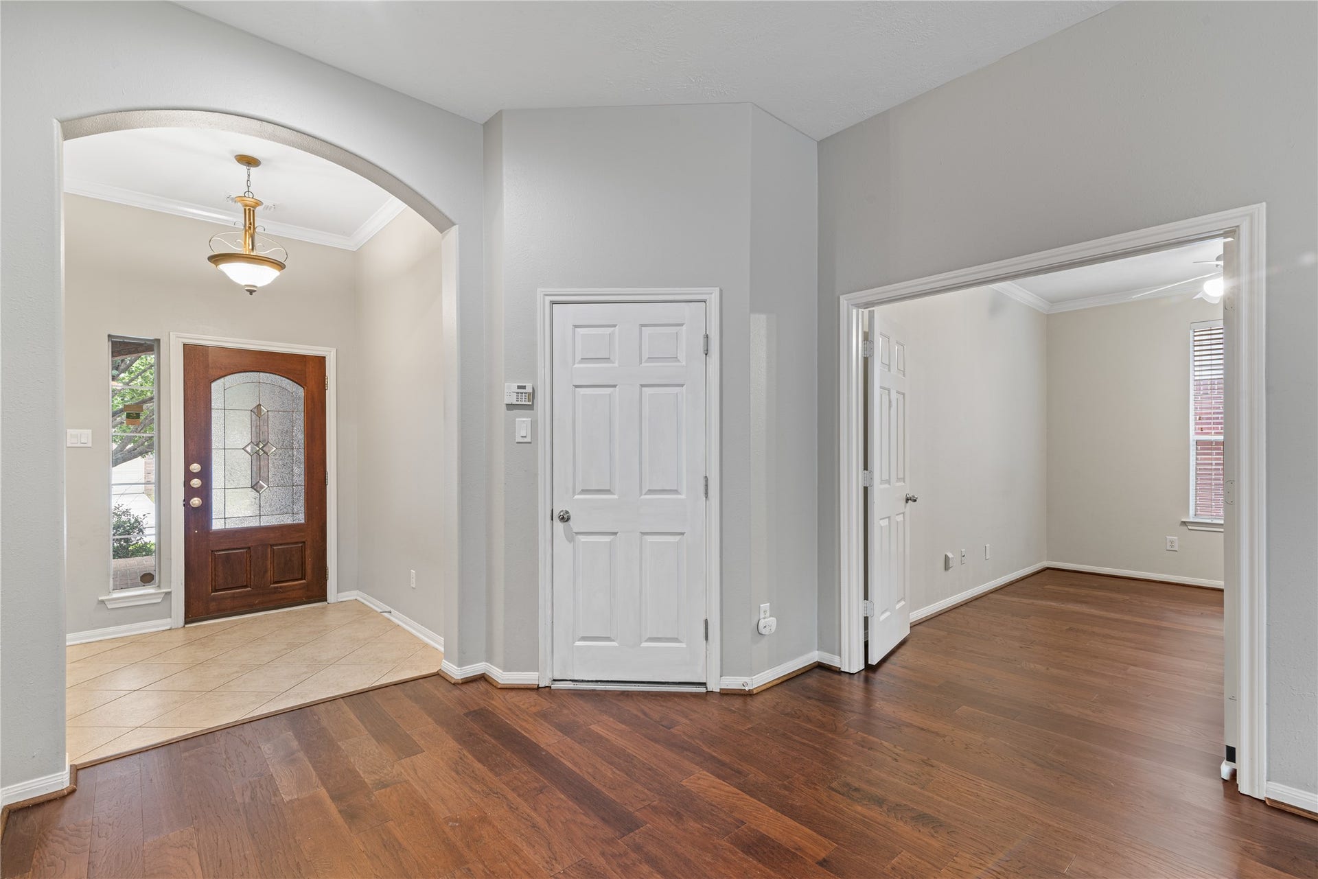 66 Bryce Branch Circle, Spring, TX 77382 Inviting entryway featuring a beautiful wooden front door with glass accents, leading to a spacious interior with an adjacent room perfect for an office or study.
