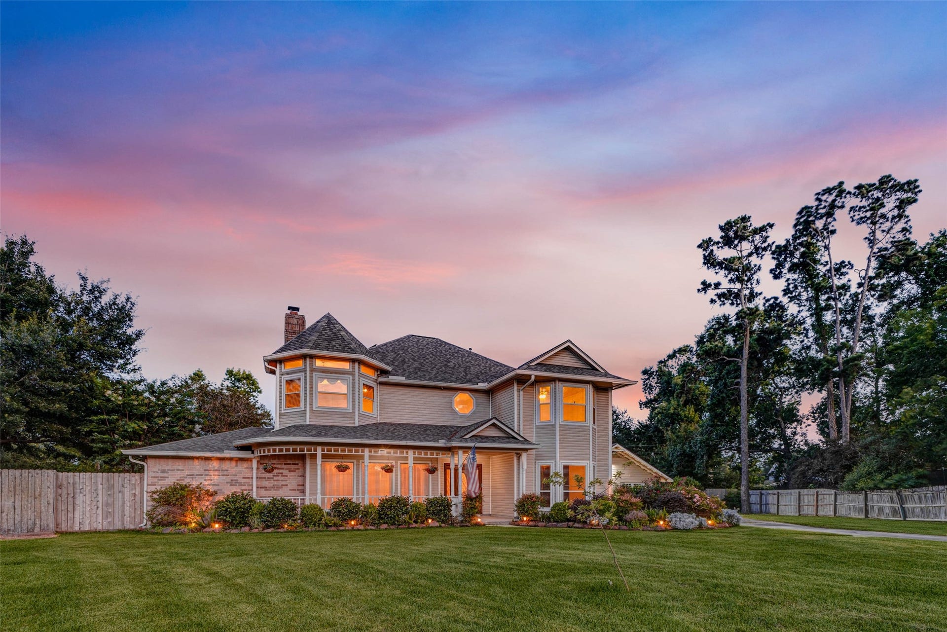11418 Cedarwood Drive, Humble, TX 77338 Framed by mature trees and a pastel twilight sky, this traditional two-story residence offers standout curb appeal on an impressive wooded lot. The broad lawn, charming porch, warm window glow, and established landscaping create a peaceful, welcoming setting. A rare blend of elegance, space, and privacy tucked within the established Ramblewood community.