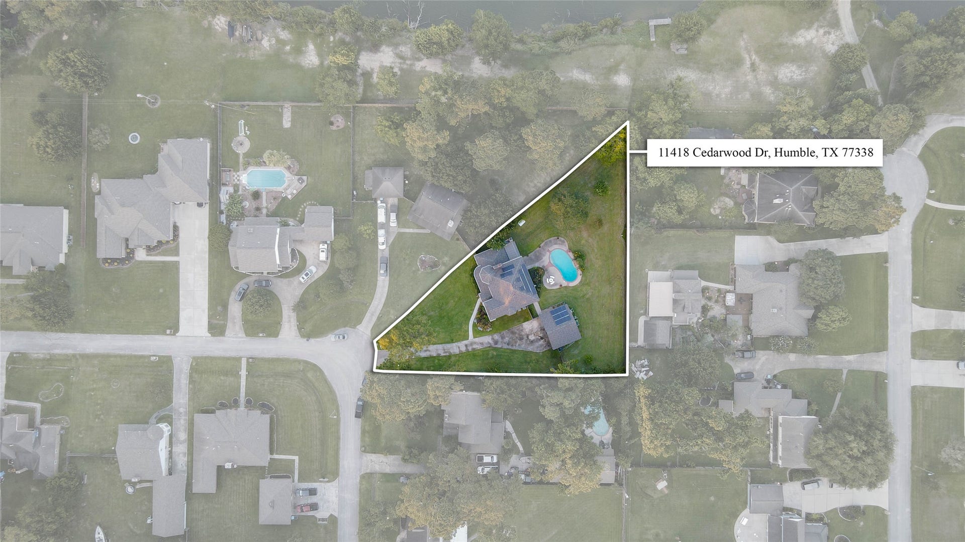 11418 Cedarwood Drive, Humble, TX 77338 This aerial boundary view captures the impressive scale and privacy of the property, outlining the expansive lot at 11418 Cedarwood Drive. The home, pool, detached garage, long driveway, mature trees, and cul-de-sac setting are all visible from above, highlighting just how much space this rare Ramblewood property provides.